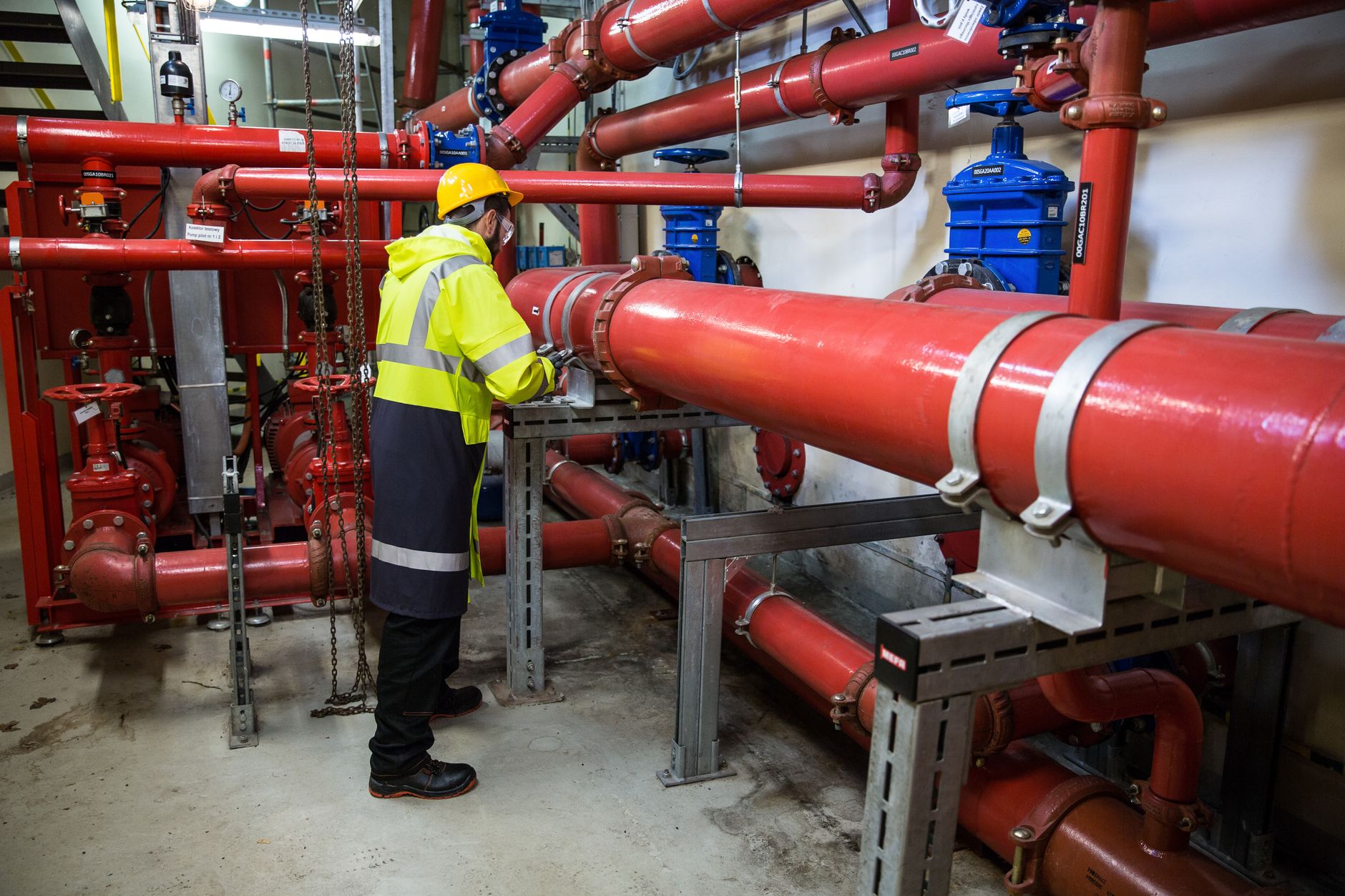 Maintenance workers examining industrial piping during a planned power plant outage.