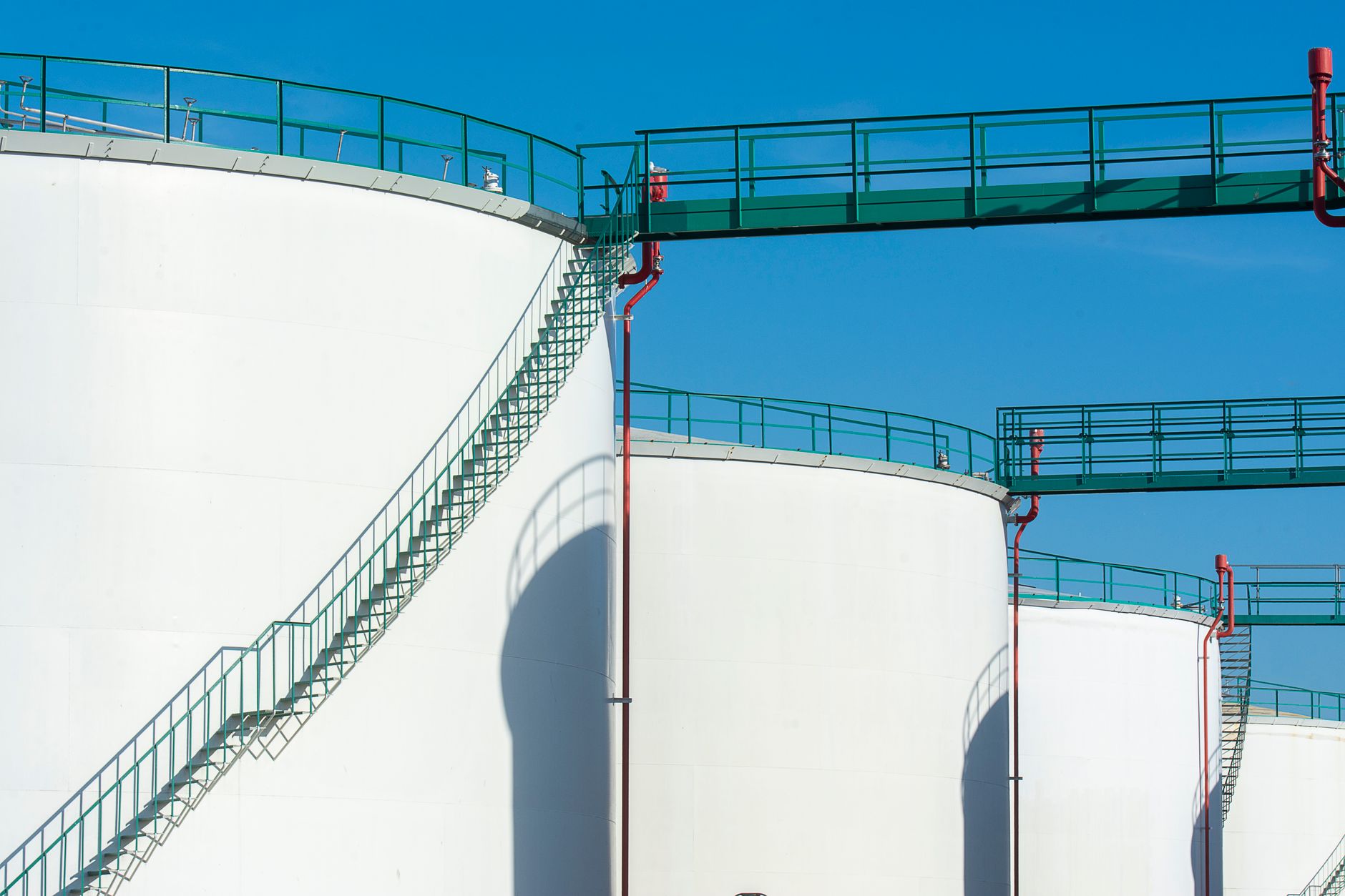 Large fuel-oil storage tanks at an industrial power facility.