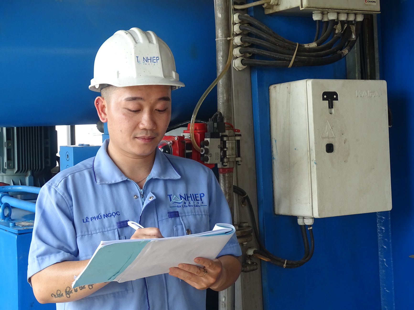 An industrial engineer inspecting refinery equipment as part of a managed maintenance program.