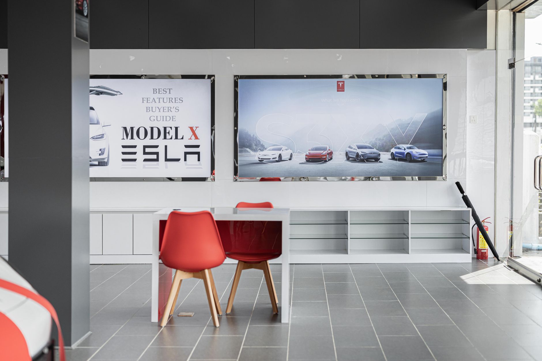 A service advisor assists a customer at the reception desk of an automotive dealership.