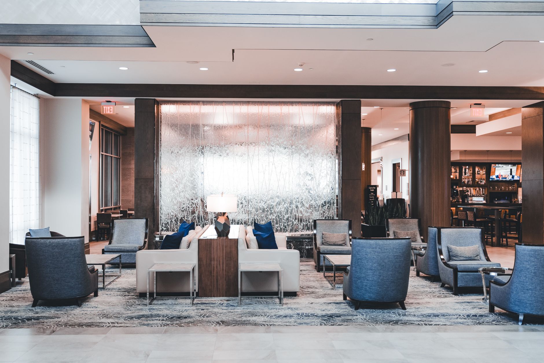 A spacious hotel lobby with seating areas where guests can pause before approaching reception.