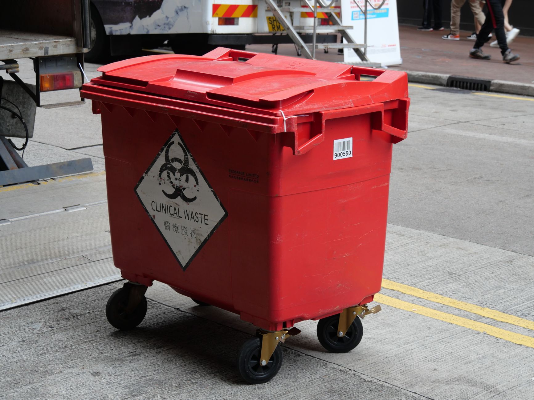 Waste handling area at a medical facility, echoing dock runs automated cart tugs support.