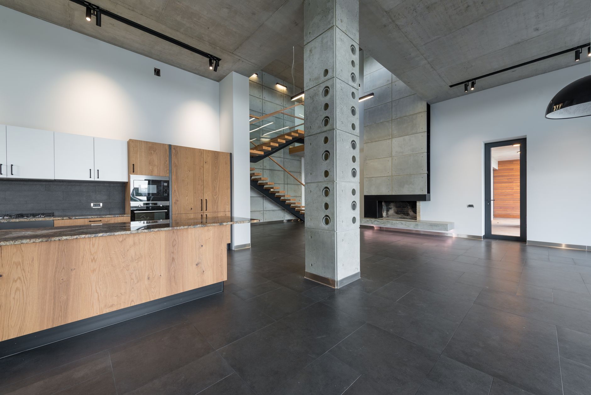 A hotel-style commercial kitchen workspace with durable flooring, representing one of the back-of-house zones that benefits from a standardized cleaning method.
