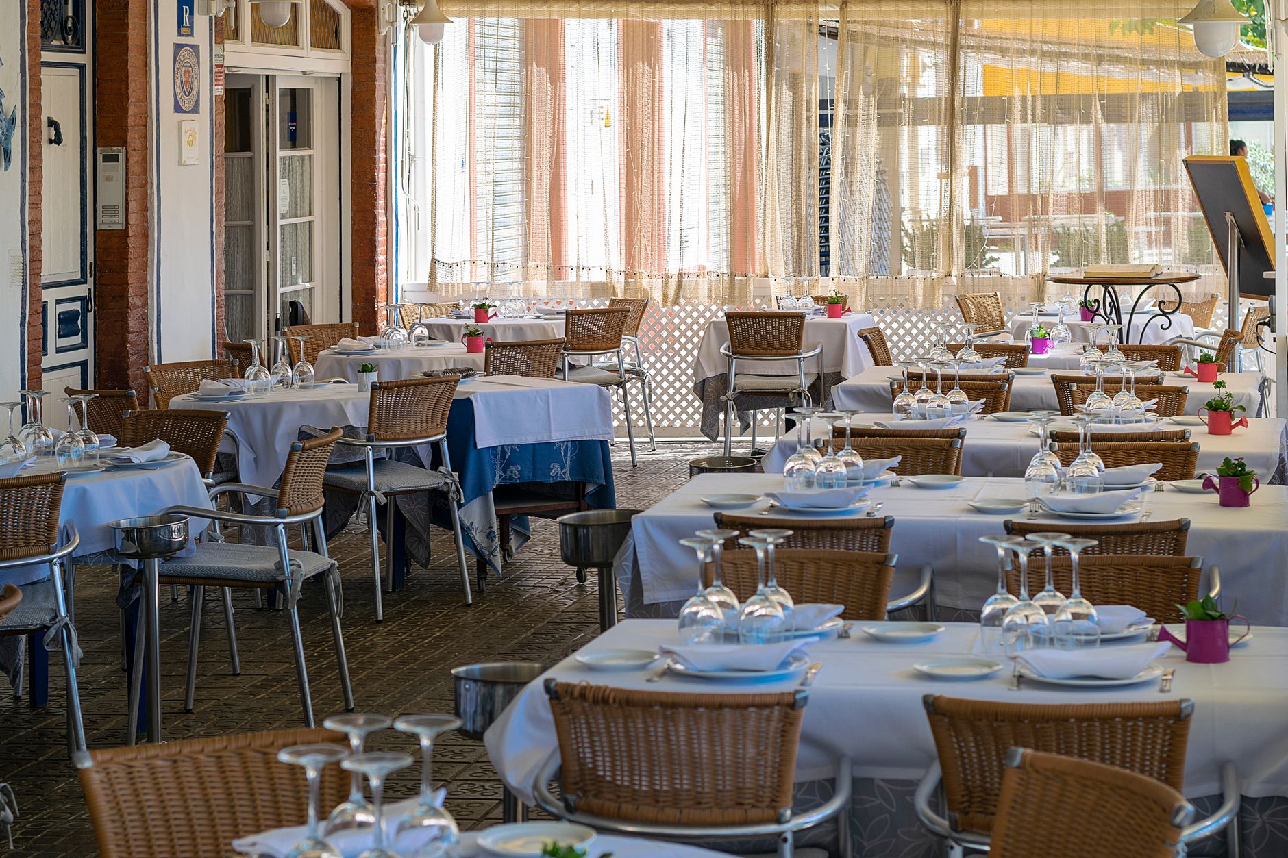 A walkway between restaurant tables where delivery paths must stay clear during service.