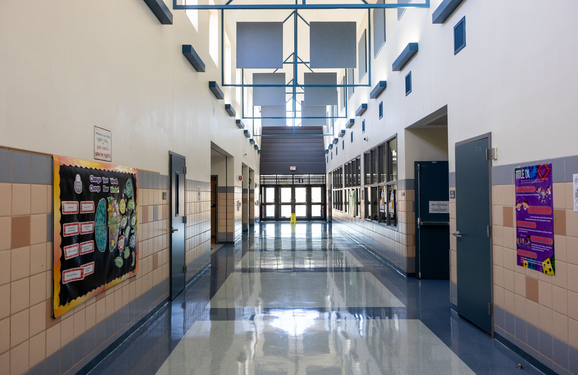 Wide view of a clean elementary school hallway, representing the large interior spaces a district has to keep presentable every day.