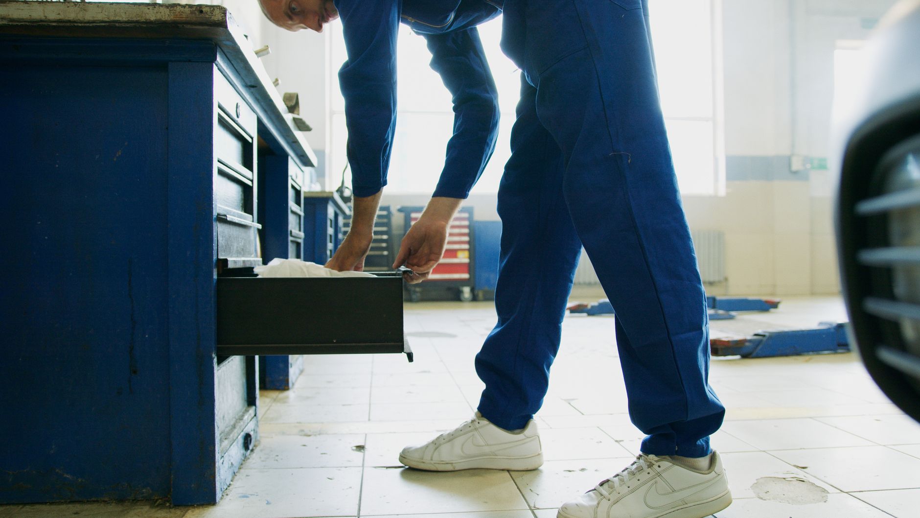 A facility technician performs routine service work in an occupied building.