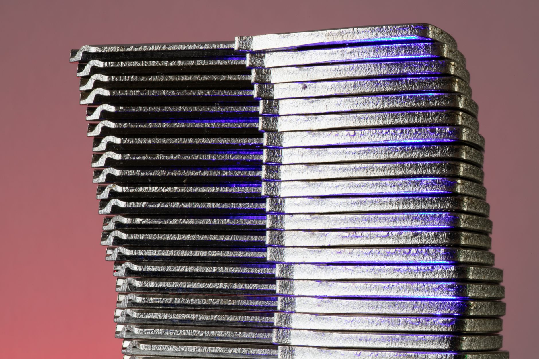 Formed sheet-metal panels stacked neatly beside a manufacturing work area.
