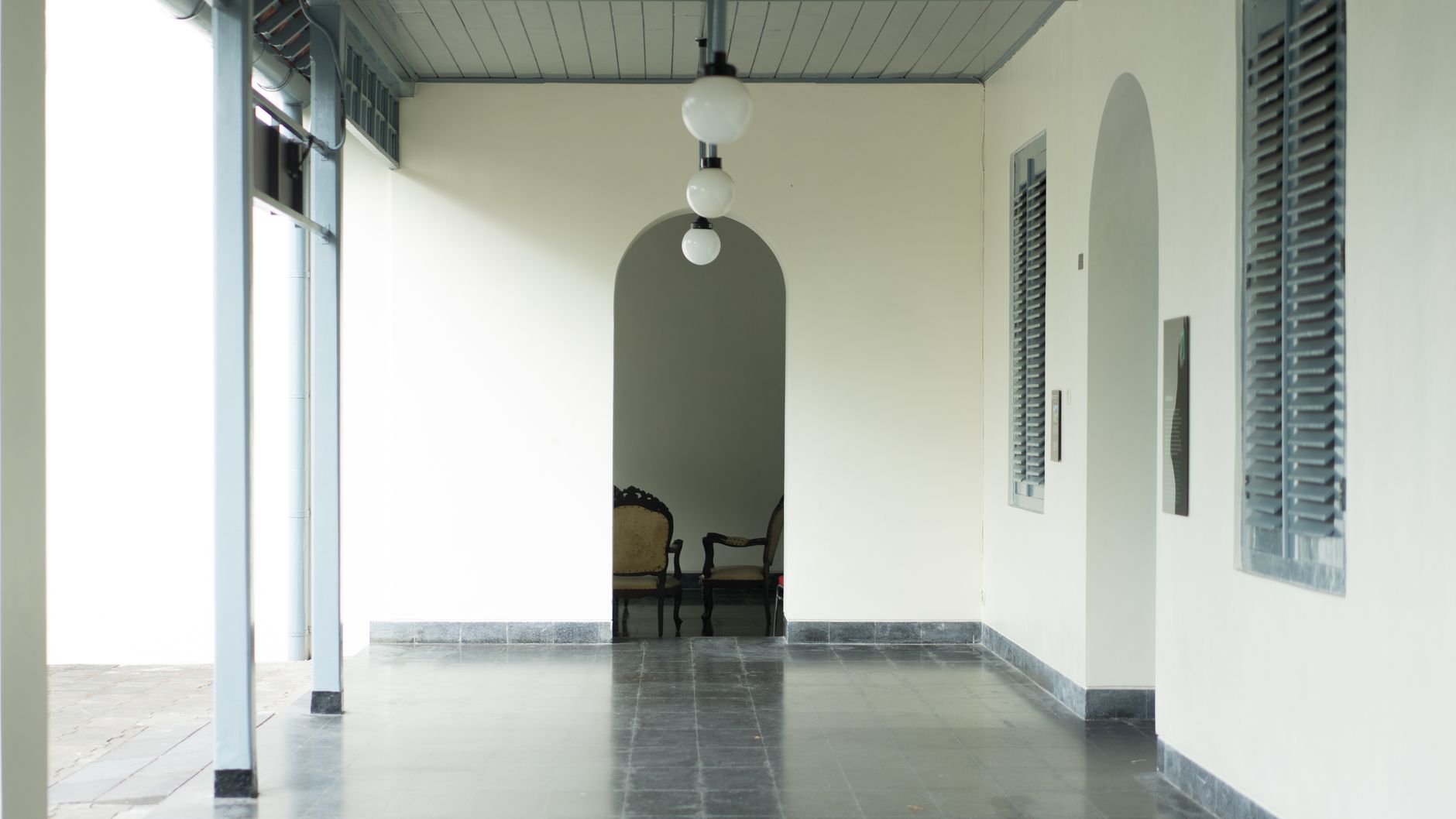 Bright hospital entrance hall with visitors walking across polished floors.