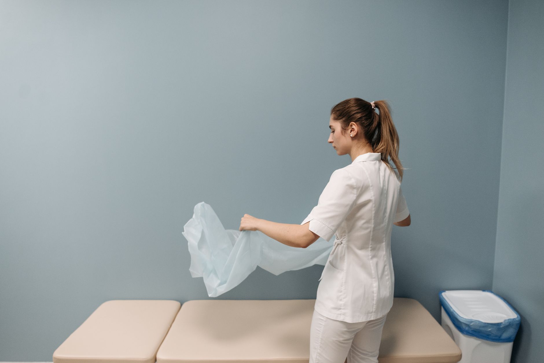 A staff member cleaning surfaces in a patient room, illustrating faster disinfection cycles without extra hands-on time.