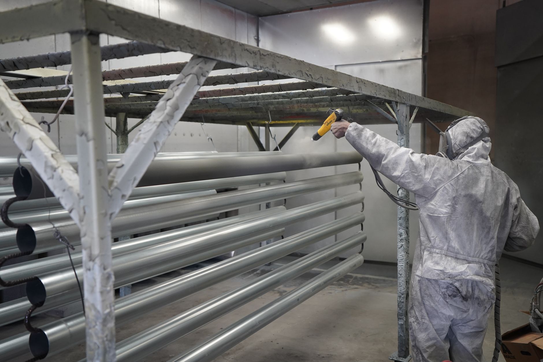 A controlled spray-finishing workspace conveys the precision and repeatability needed for coating loudspeaker membranes.