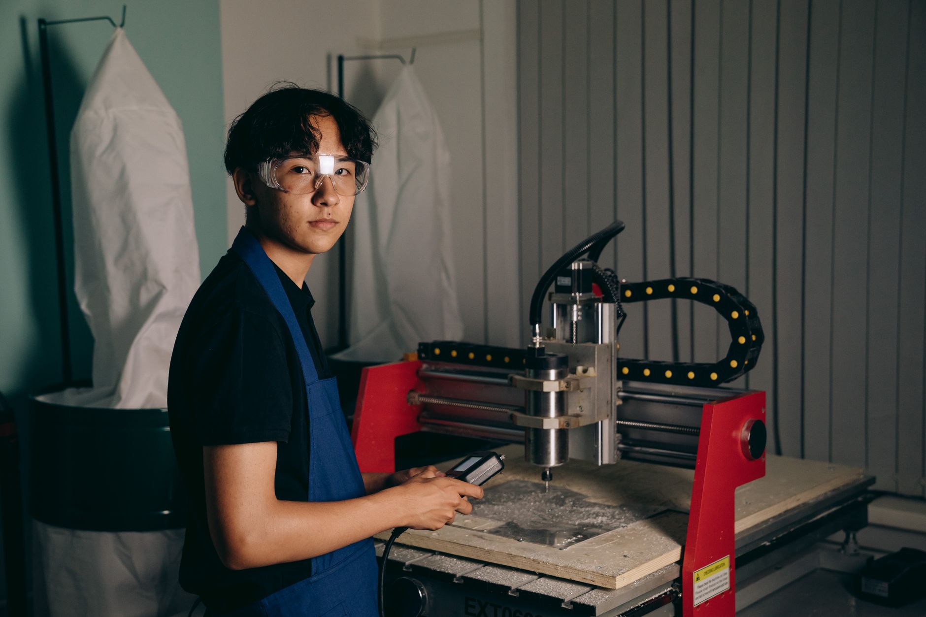 An operator reviews equipment controls on the factory floor, reflecting the training and rollout needs of a precision coating cell.
