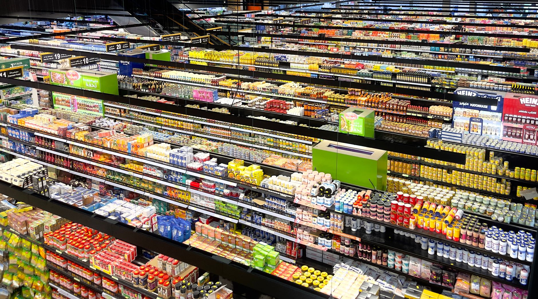 Long retail aisles with fully stocked shelving, representing the repetitive storewide passes needed for consistent inventory counting.