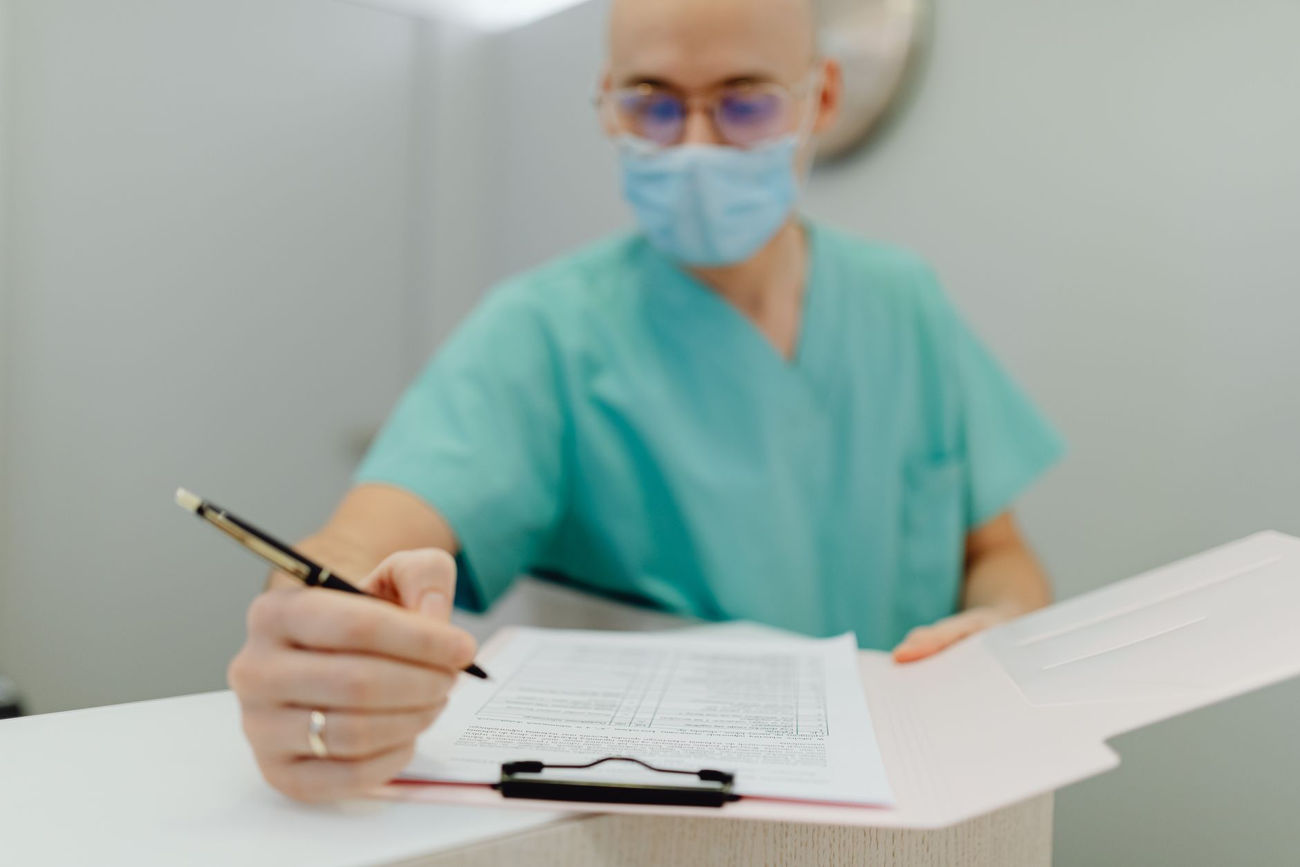 Infection prevention staff reviewing a checklist beside a hospital work station