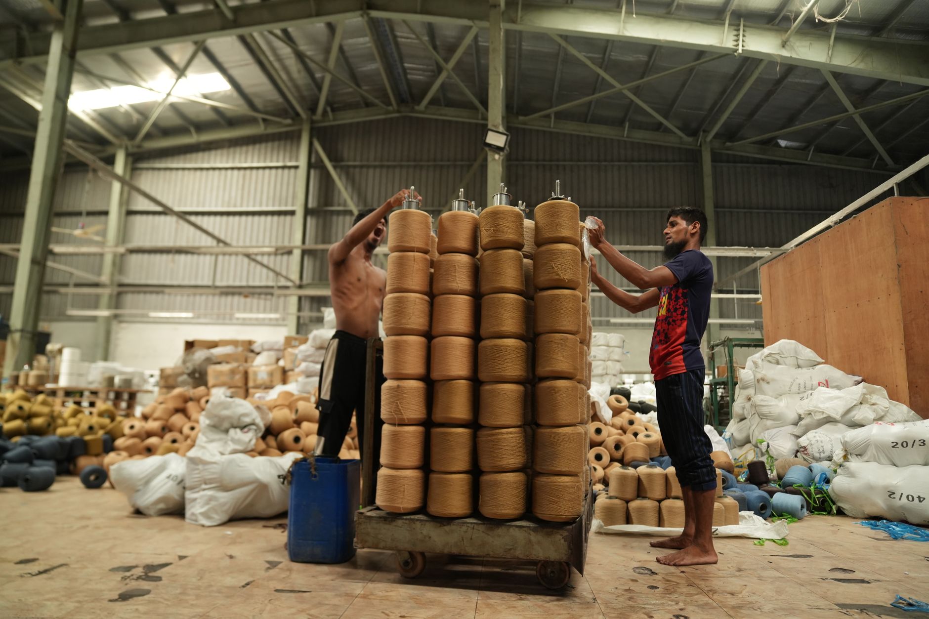Yarn cones and textile supplies staged for production lines