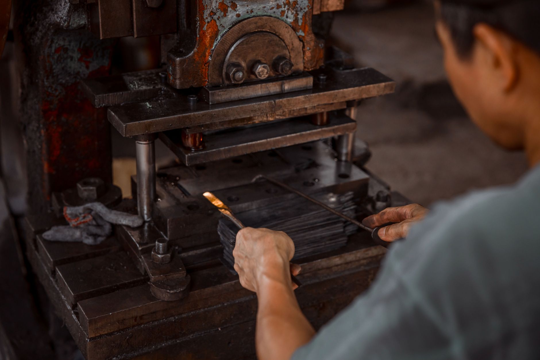 Industrial press area with heavy steel forming equipment typical of structural metal fabrication.