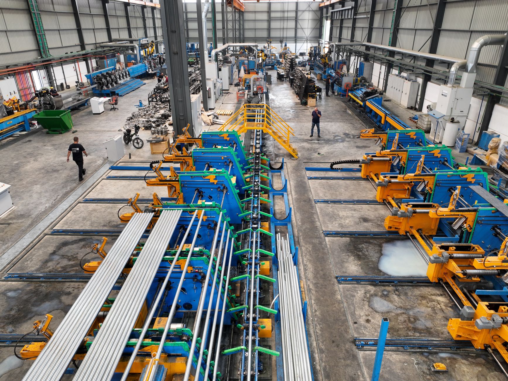 Wide view of a heavy manufacturing floor where large steel trailer components are produced.