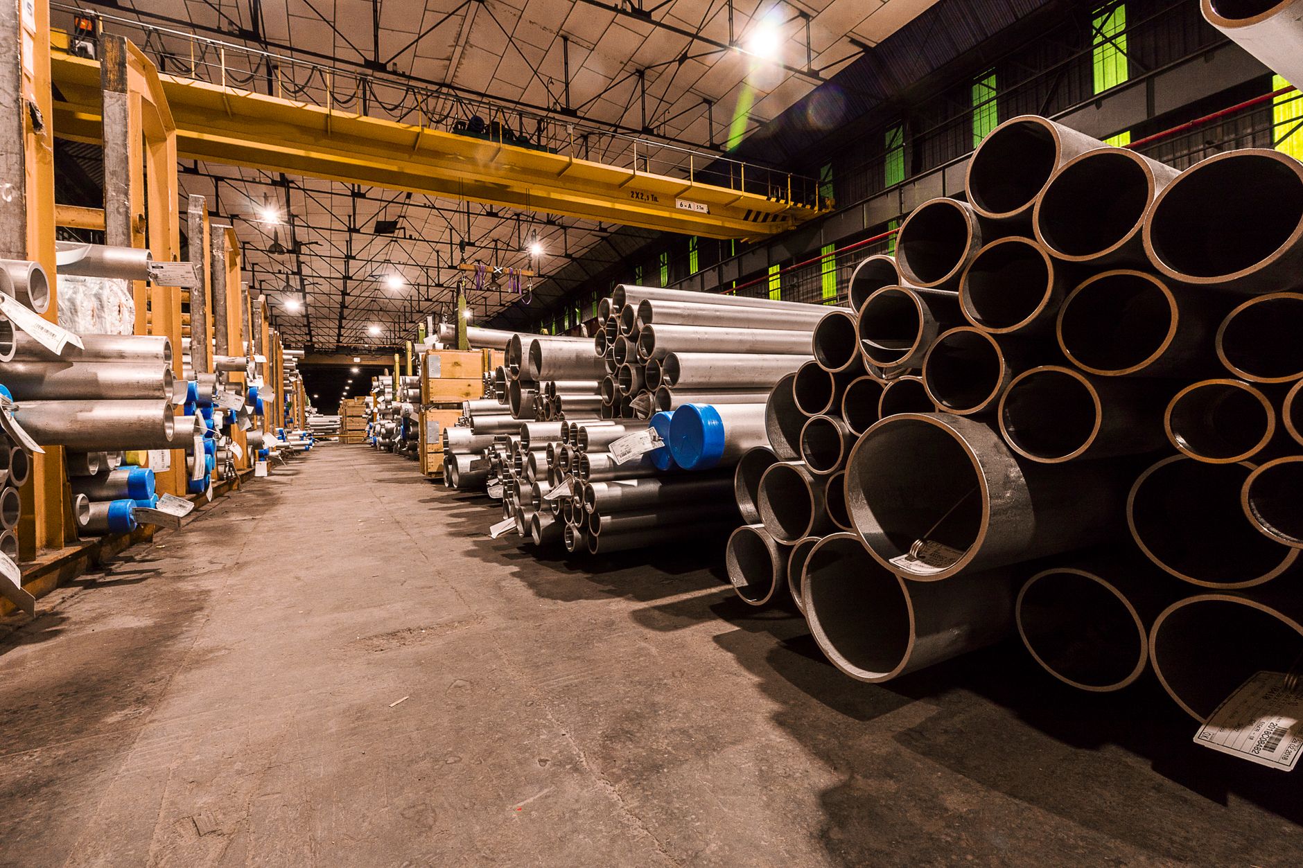 Stacks of metal tubes representing the fifteen-hundred-piece mandrel bender run completed in four hours.