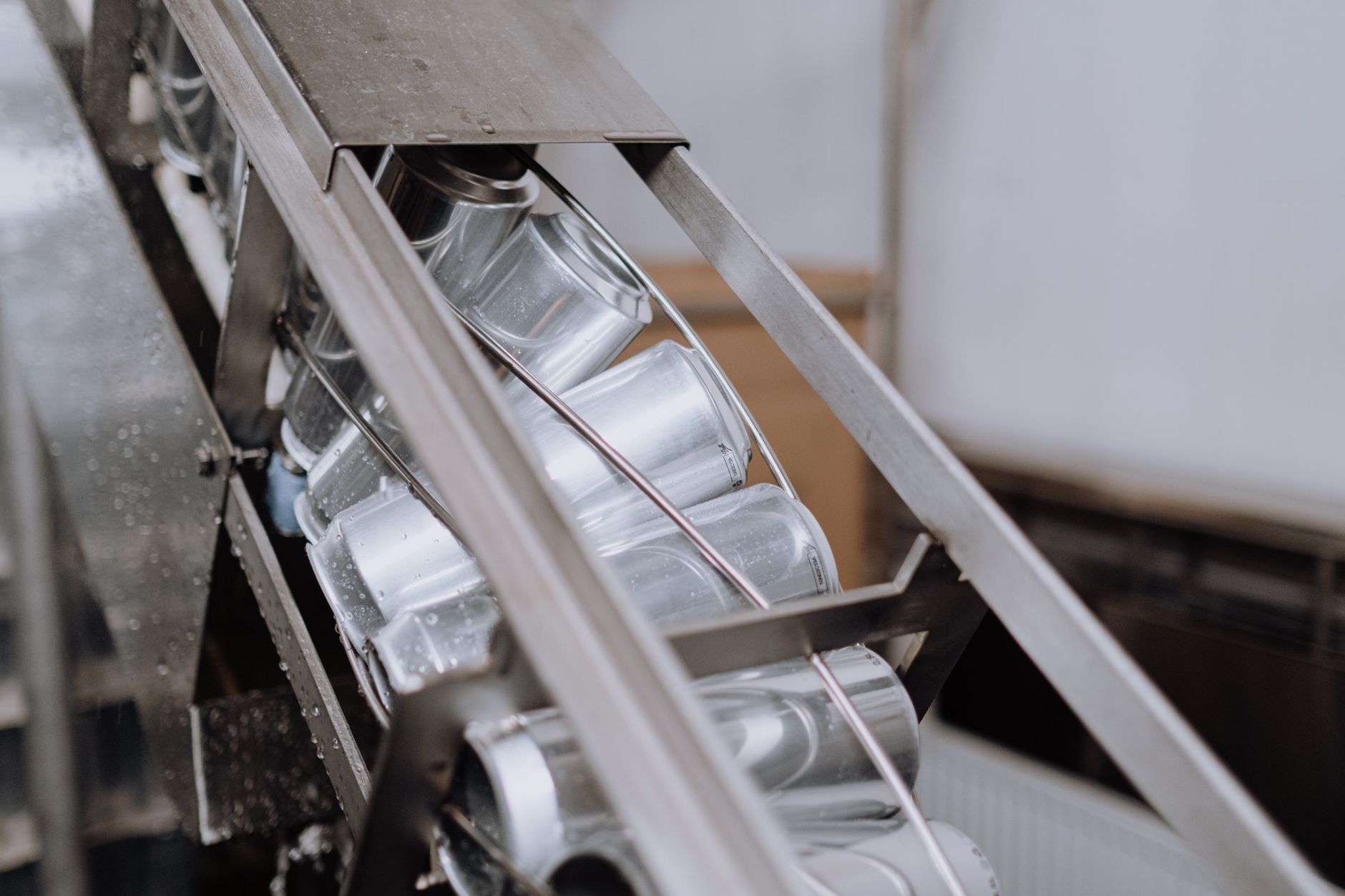 Aluminum containers moving along a recycling conveyor, matching the quality-control line where the facility measured its biggest gains.