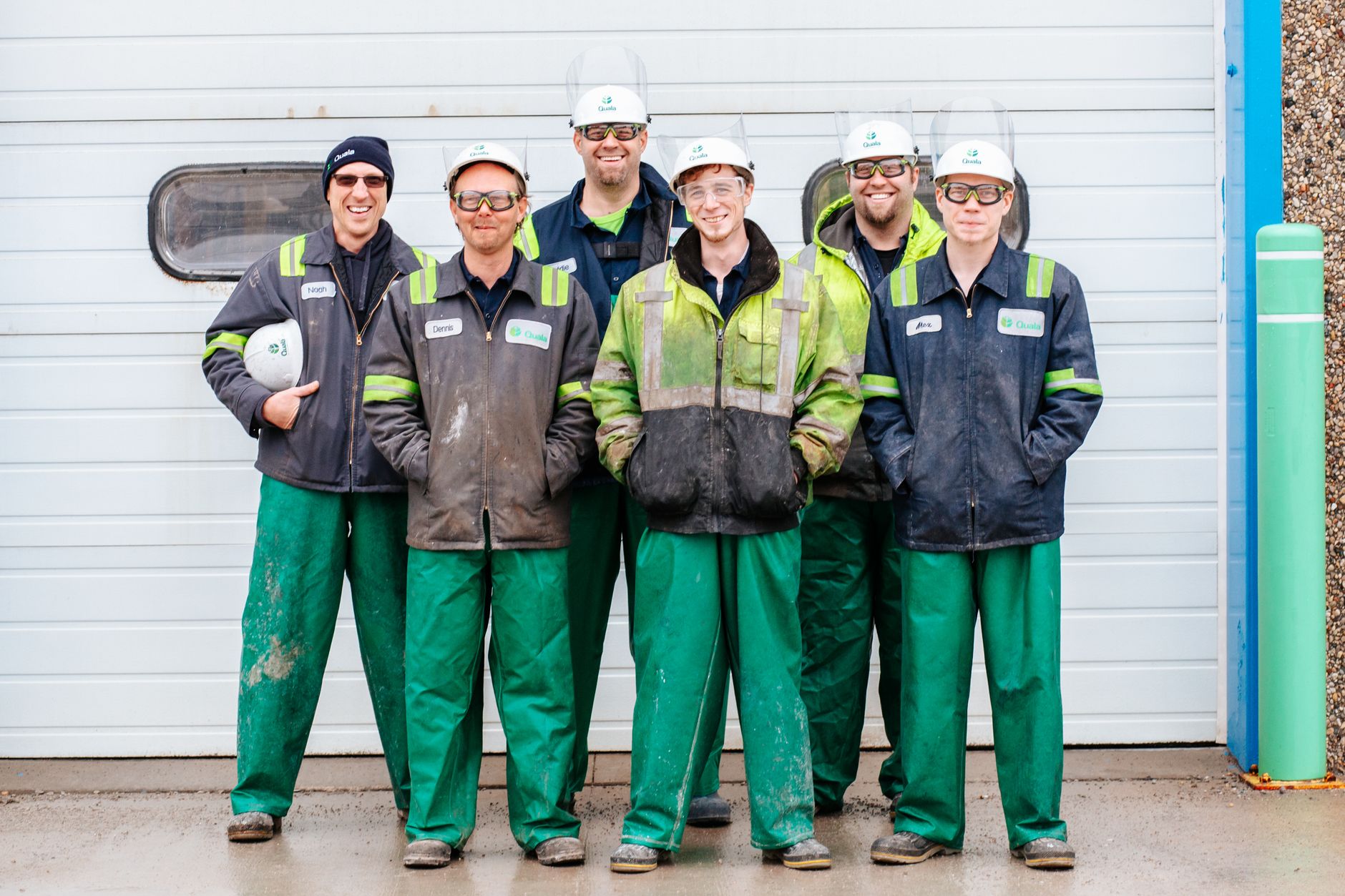 A plant operations team conferring on an industrial floor, representing the hands-on rollout, training, and support needed for a live recycling retrofit.