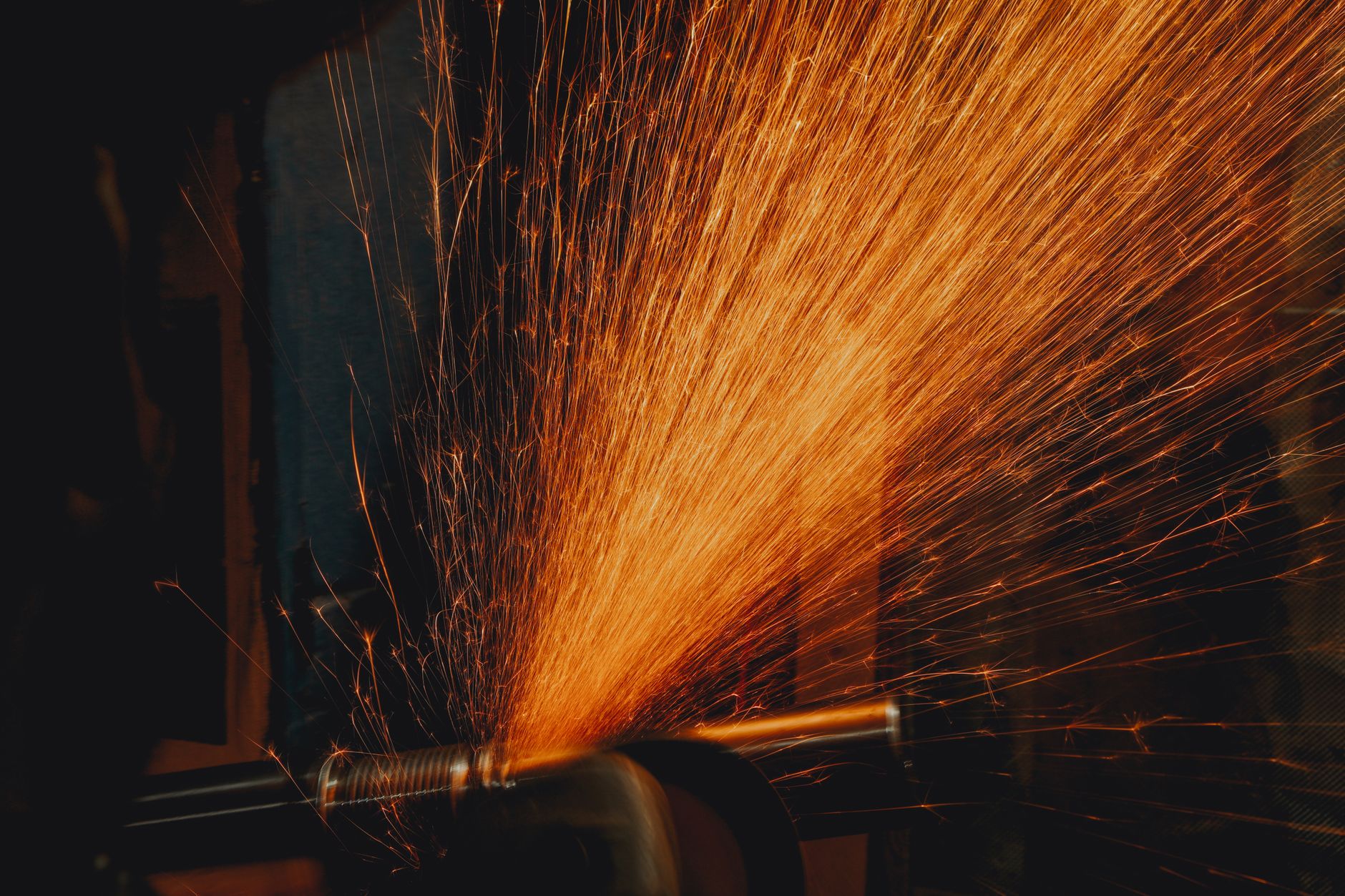 Manual grinding sparks, the kind of hand filing work the plant reduced with robots.