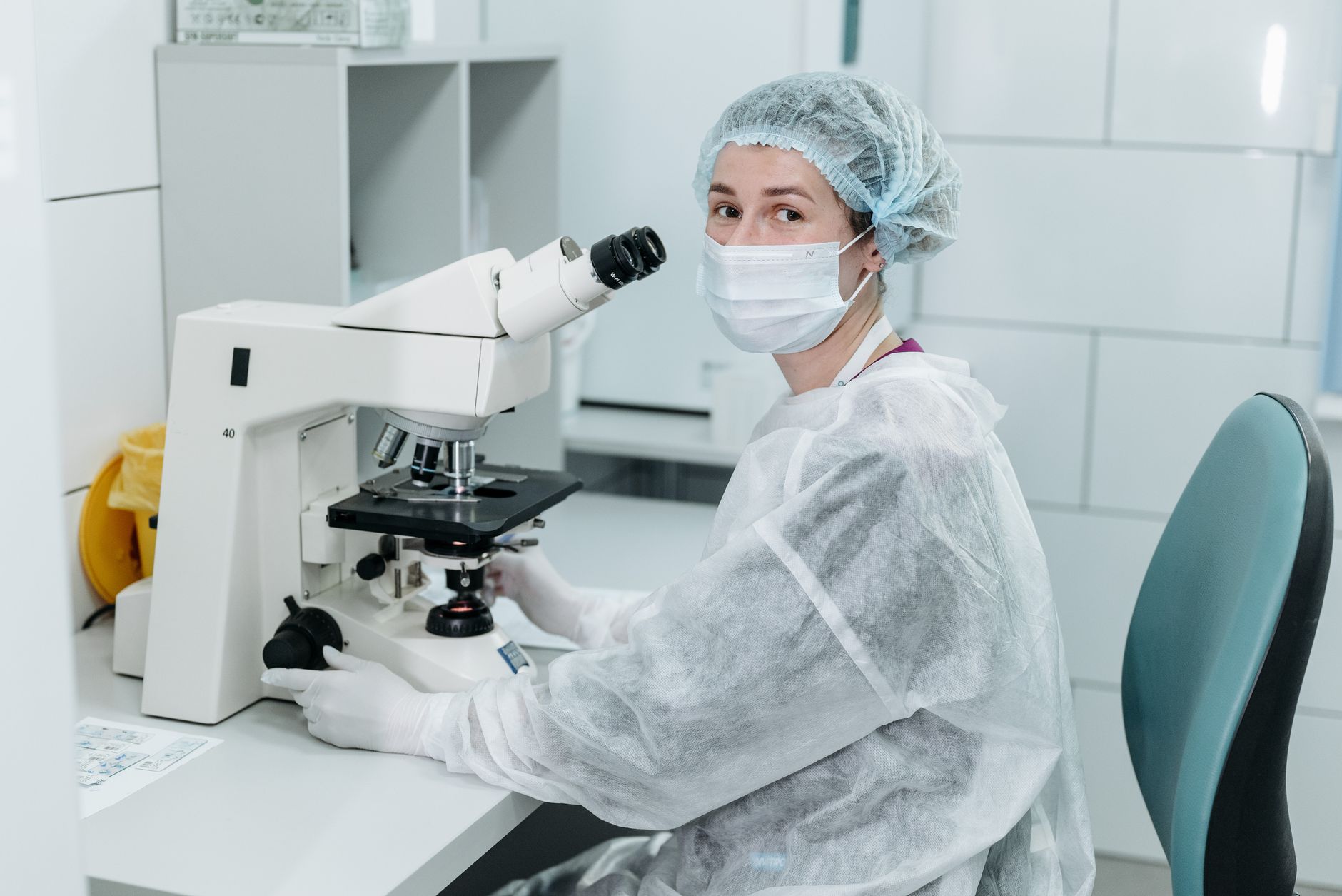 A laboratory technician prepares blood sample tubes at a clinical testing bench.