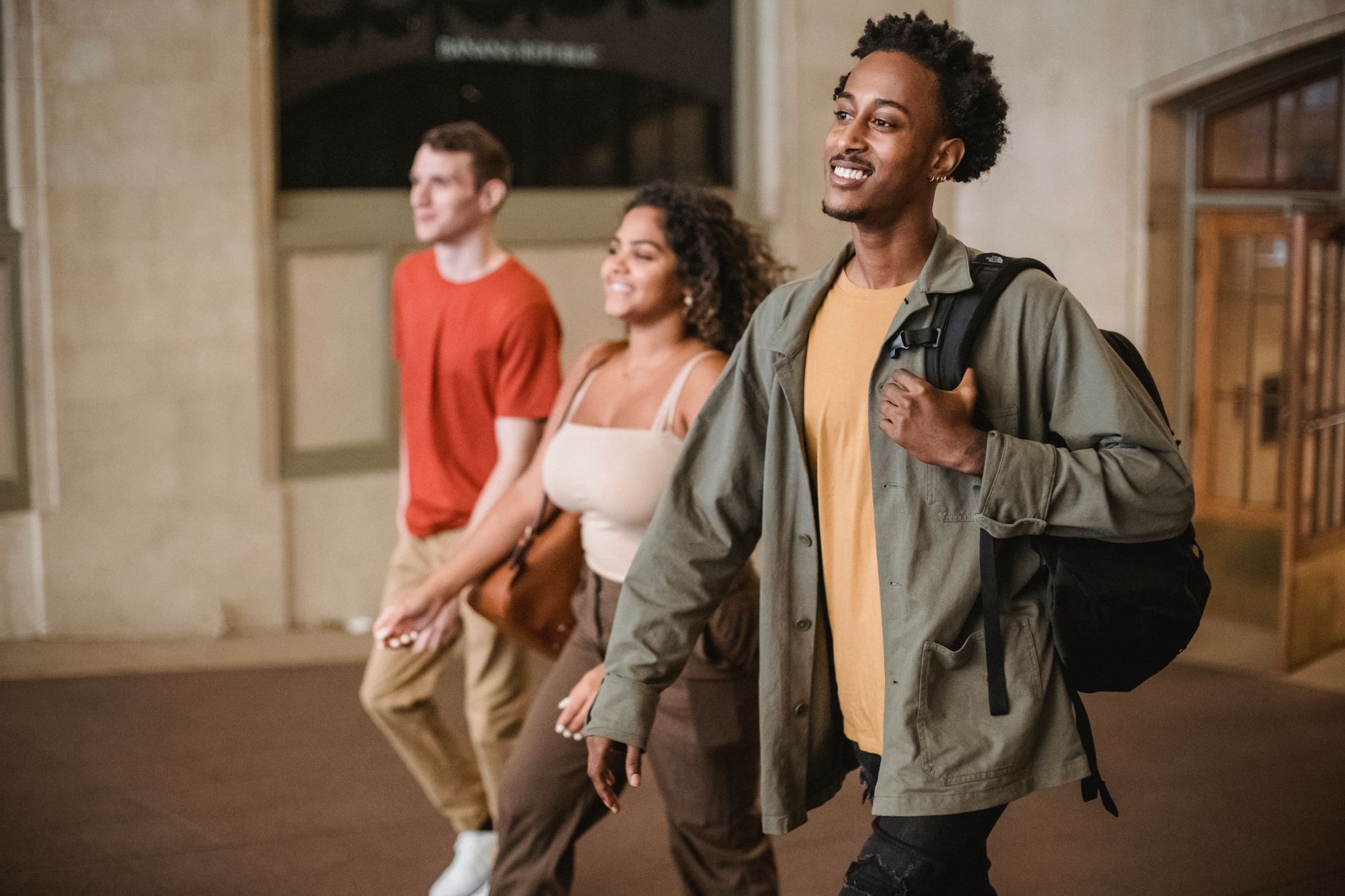 Students moving through a campus hallway where early-morning floor readiness affects the whole building opening.