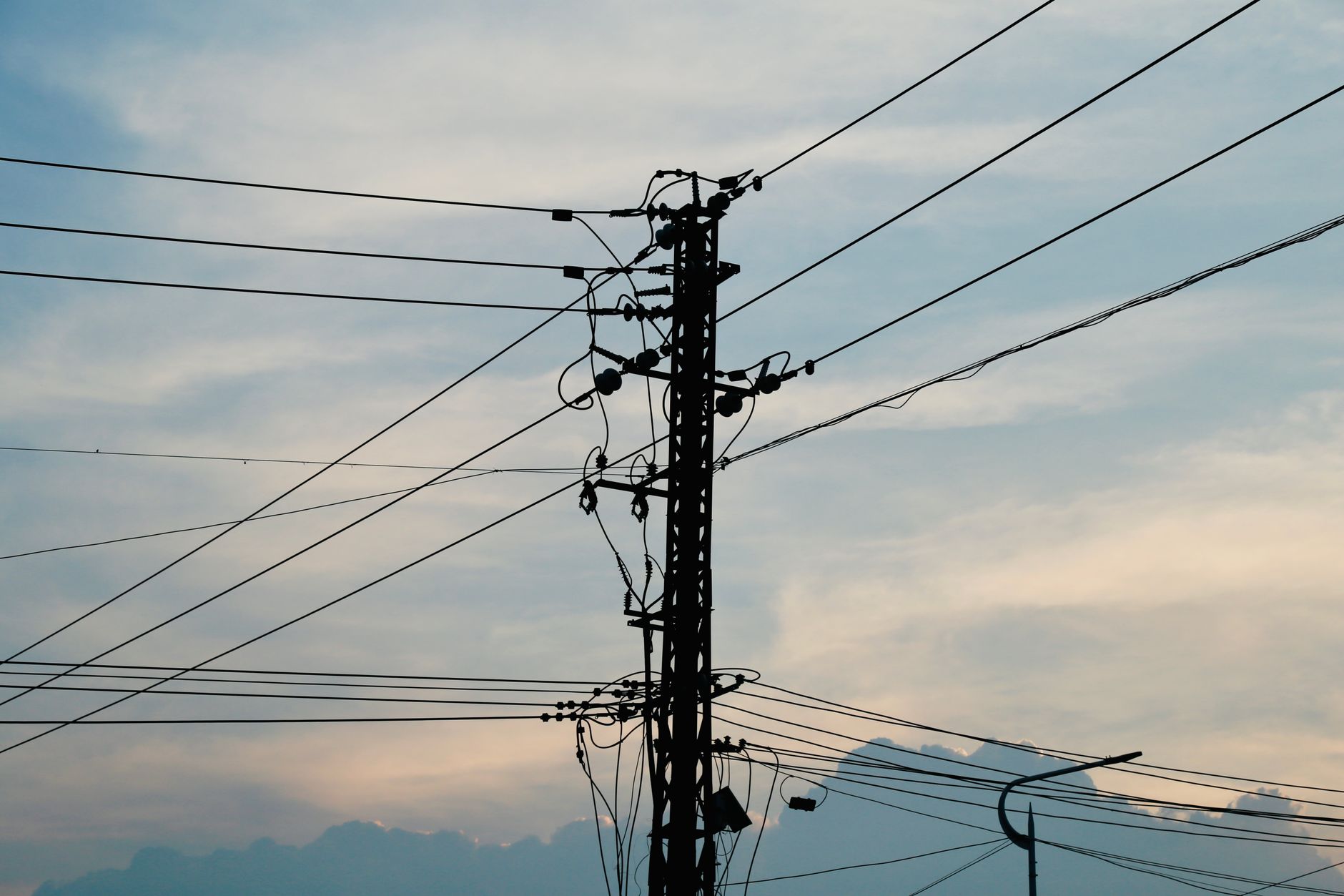 A row of utility poles along a rural road, the kind of distributed assets a drone survey must cover in days instead of months.