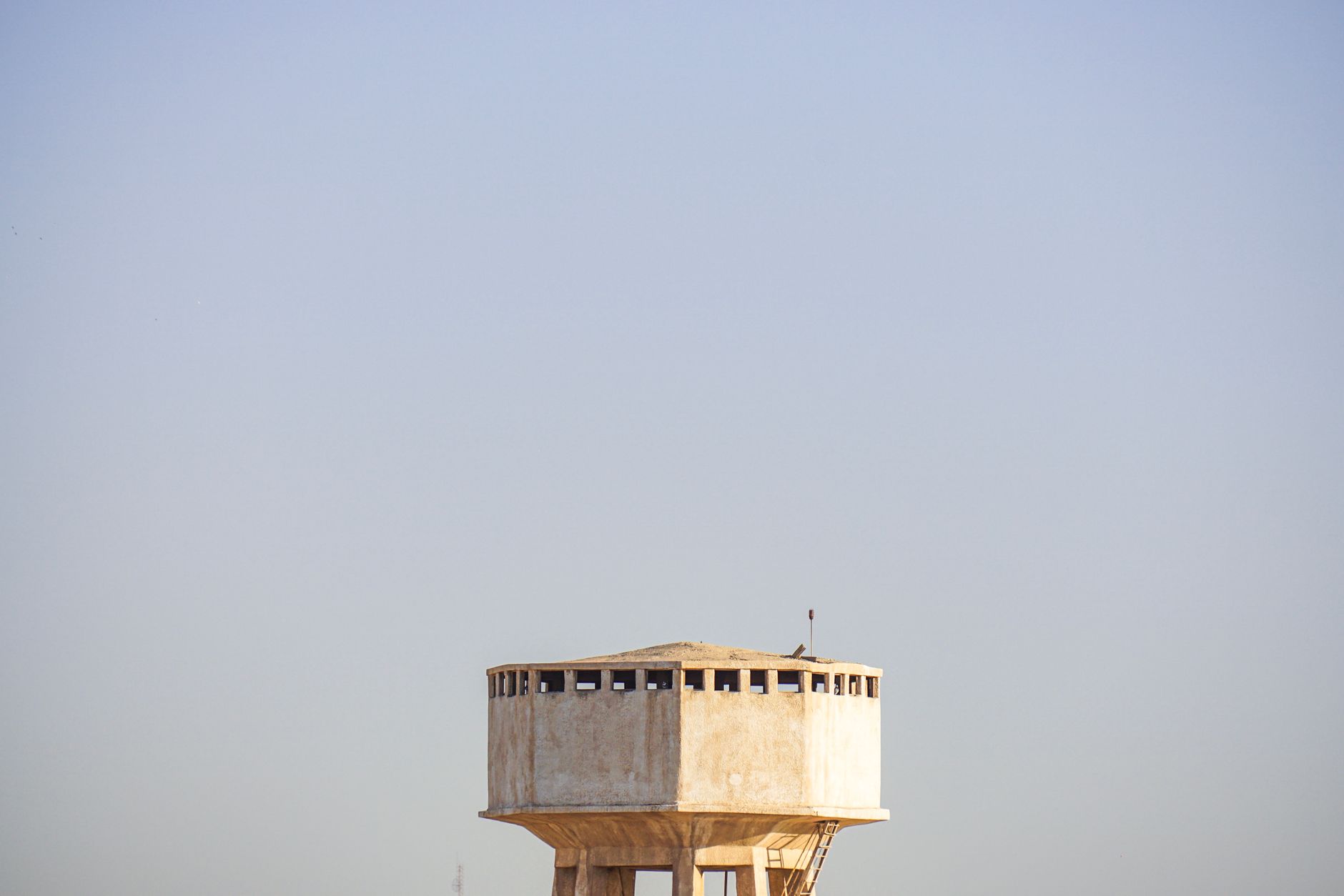 A municipal water tower rising above the surrounding service area.