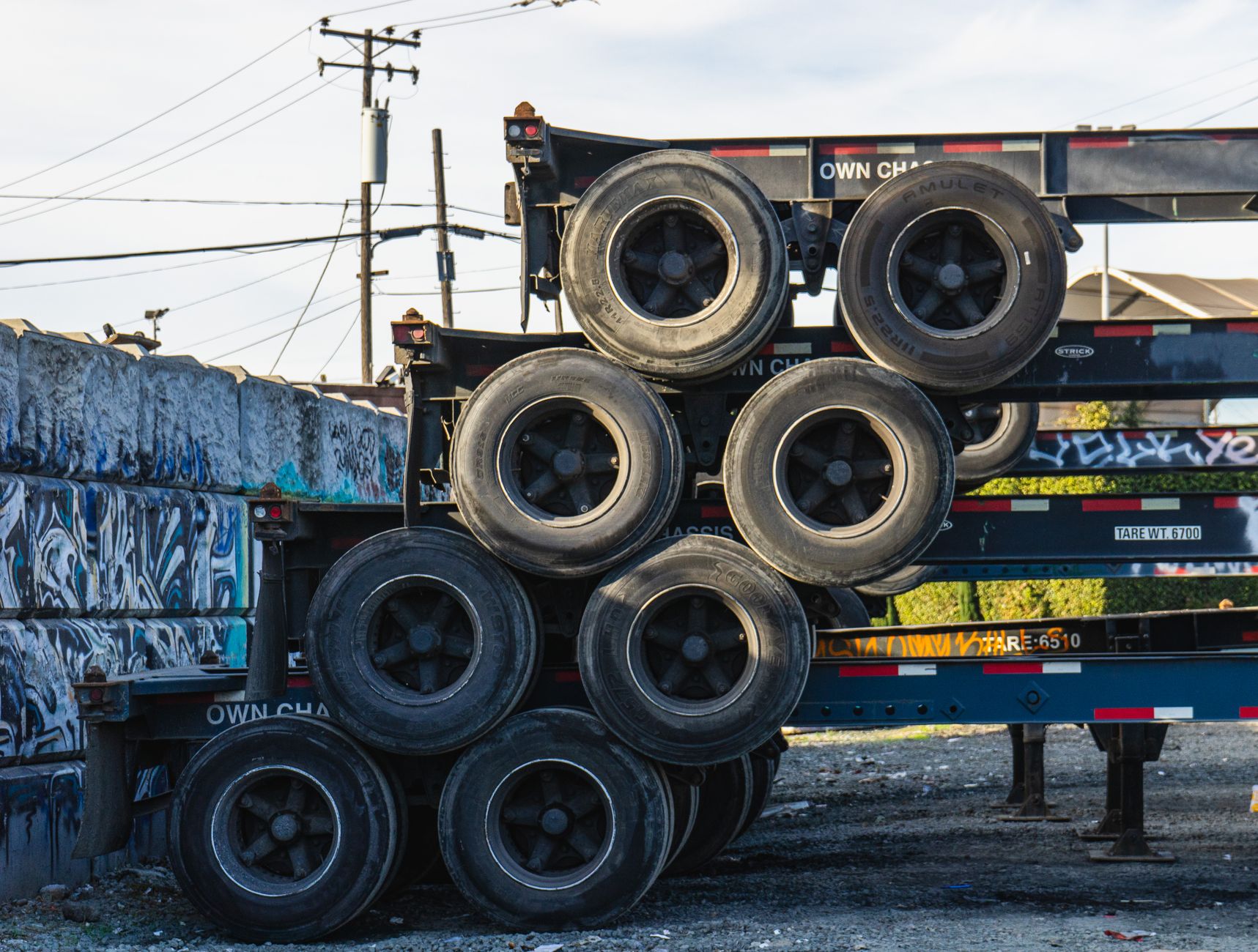 Stacks of alloy wheels on pallets with layer separators similar to the dunnage described in the case.