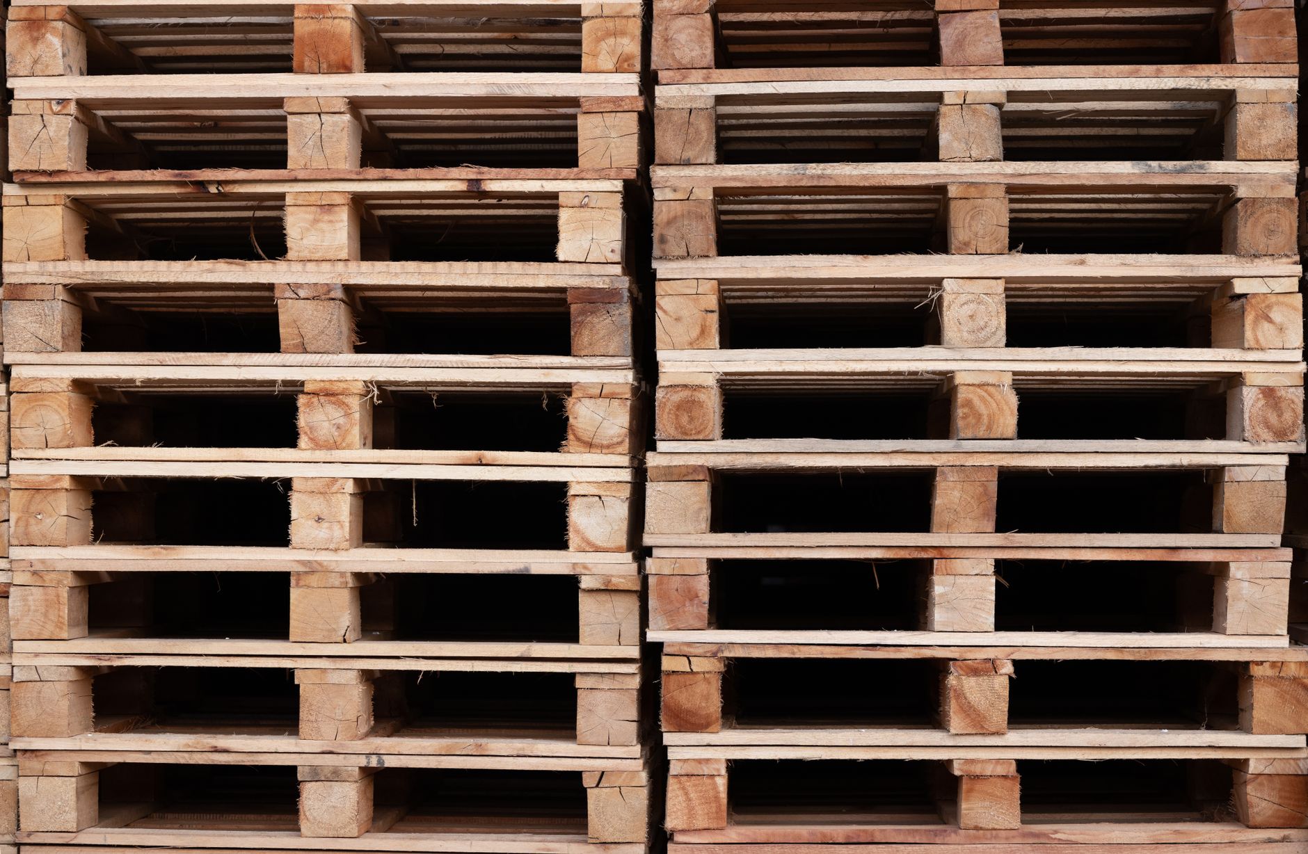 Pallets of finished wine cases staged inside a winery warehouse for distribution.