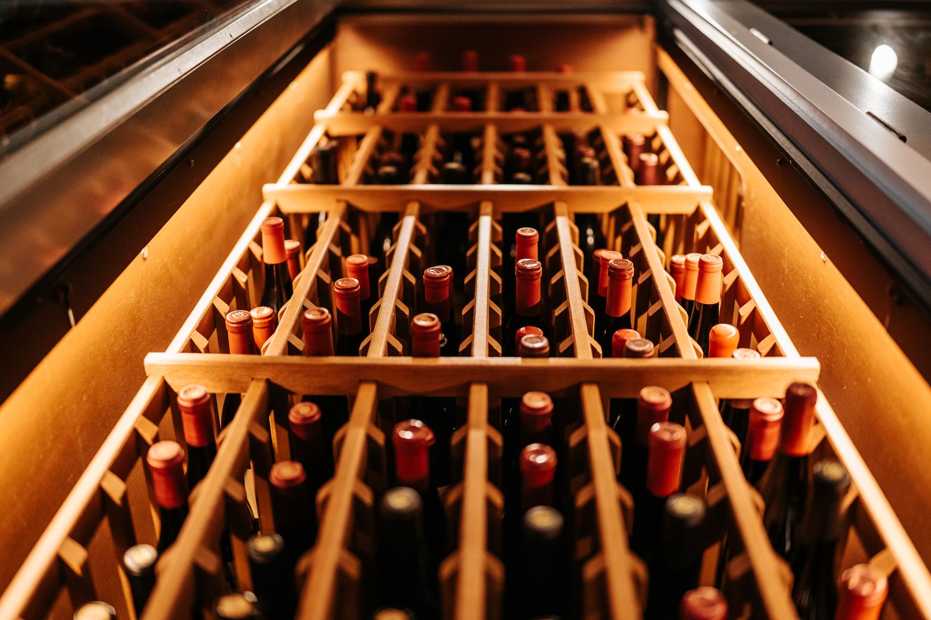 Winery employees packing bottled wine into cases on a busy production floor.
