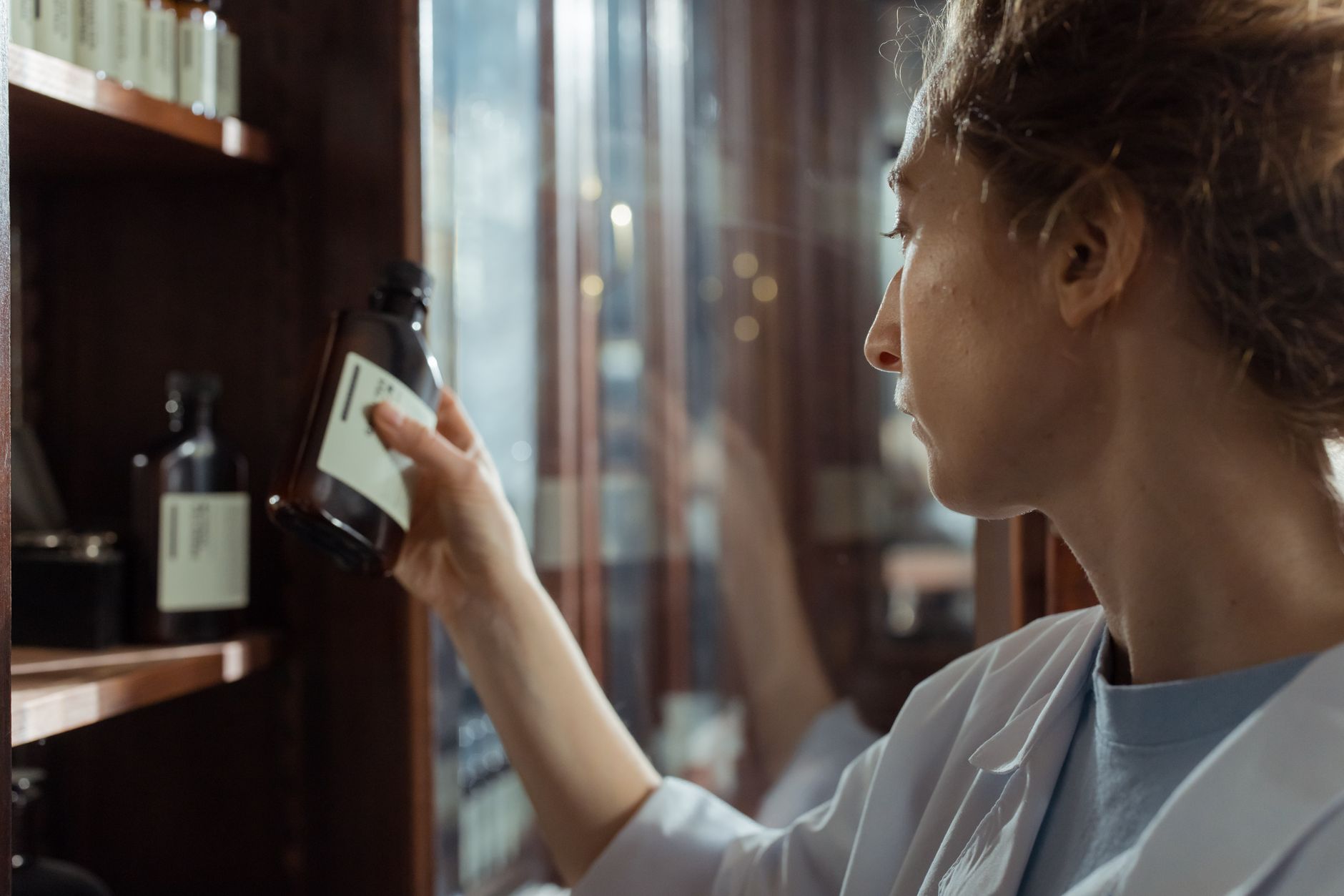 A pharmacist scanning a medication vial as part of a verified sterile preparation workflow.