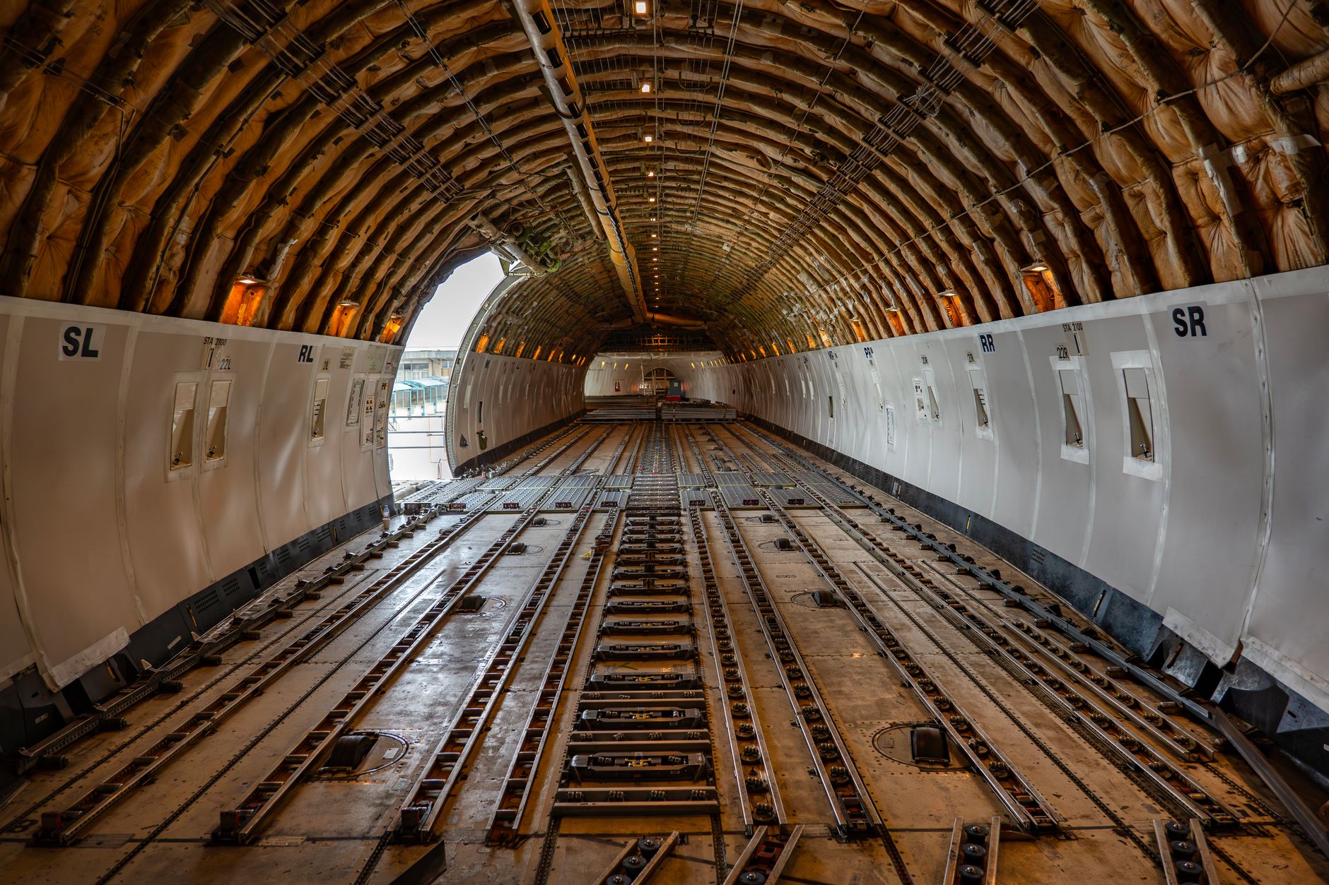 Palletized air cargo staged inside a large freight warehouse near loading bays.
