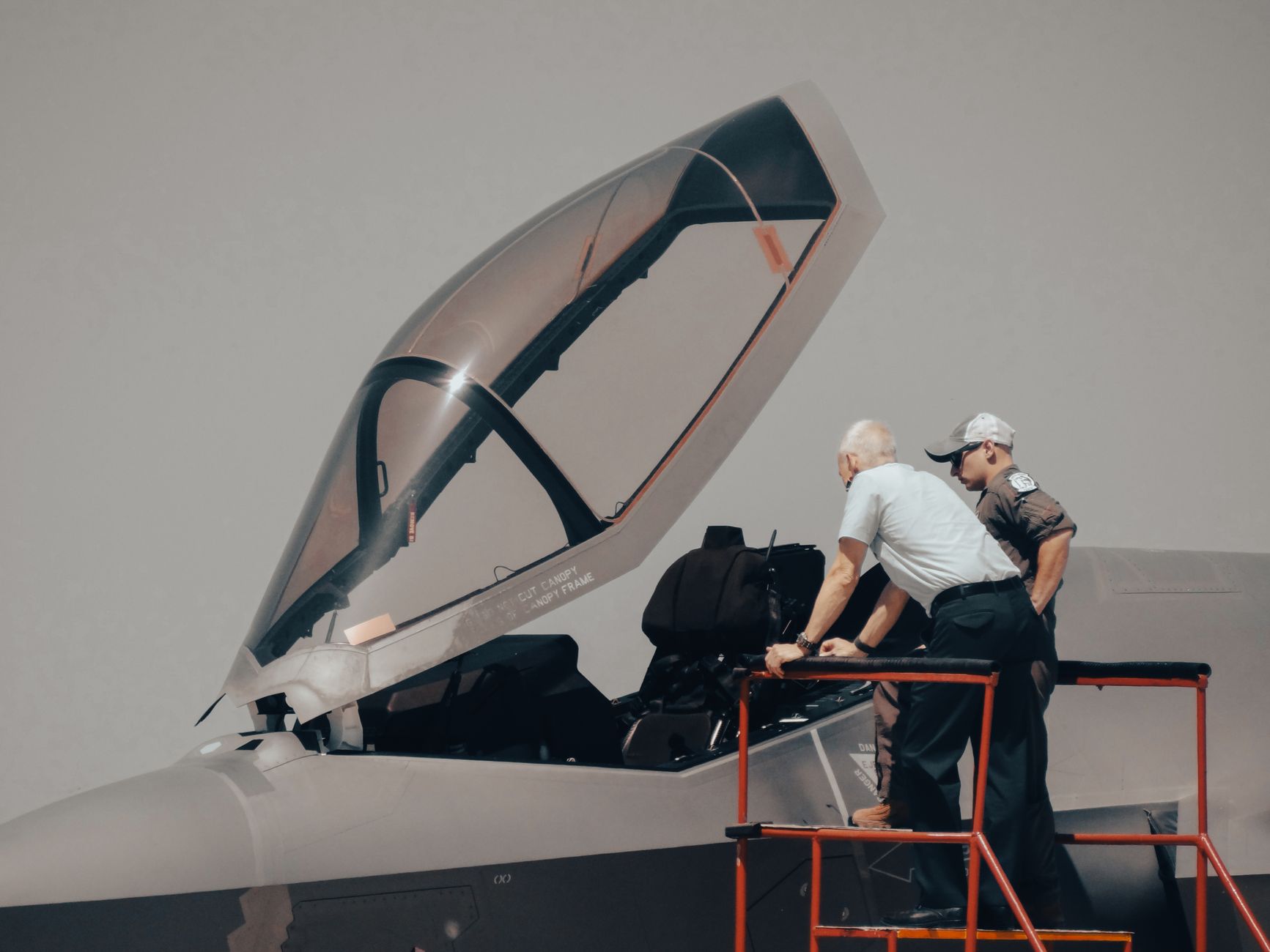 An aircraft maintenance crew preparing together on the floor of a commercial hangar.