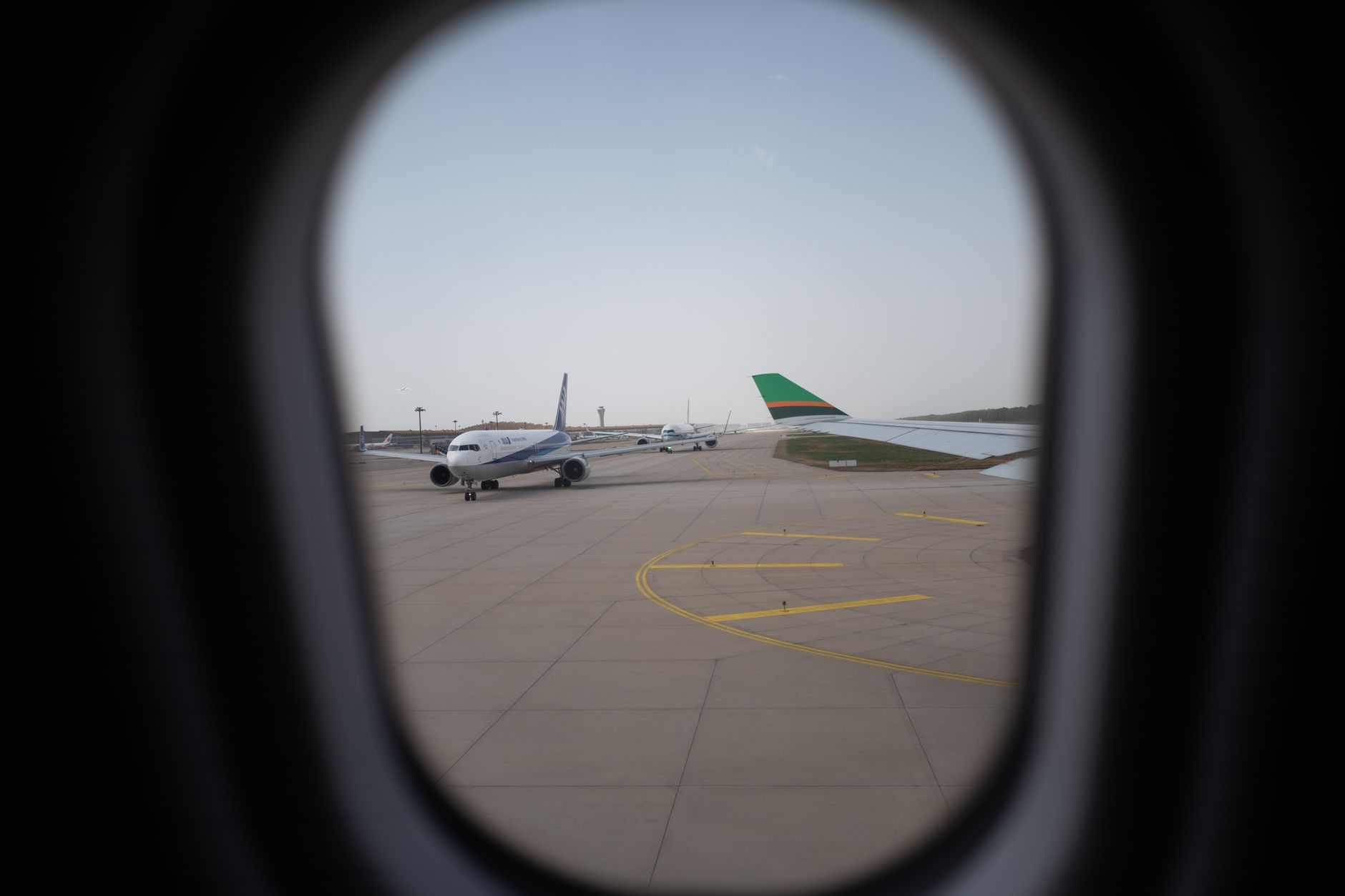 A commercial airliner parked on an airport apron during ground operations.