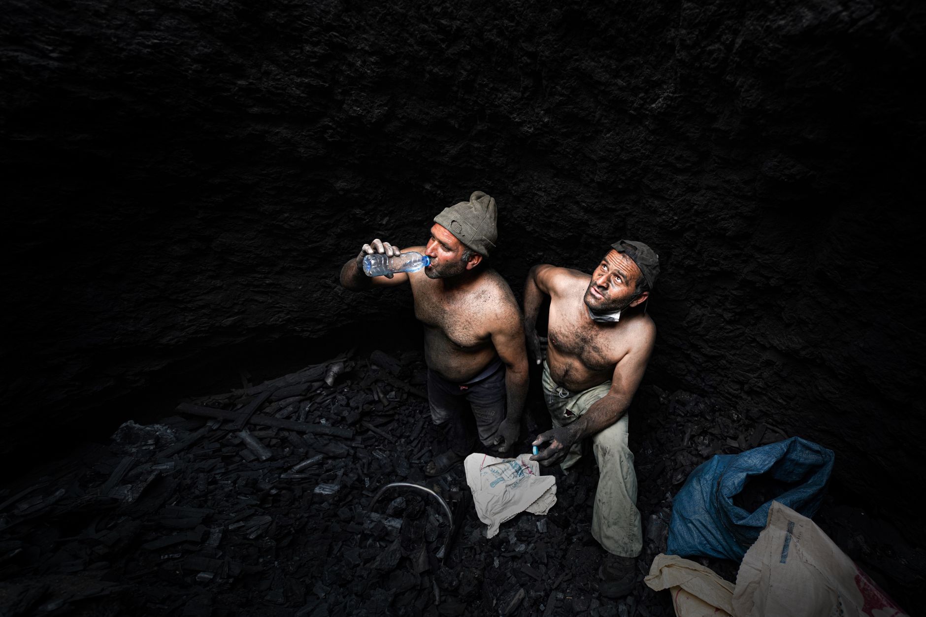 A mine worker inspecting an active underground heading during field operations.