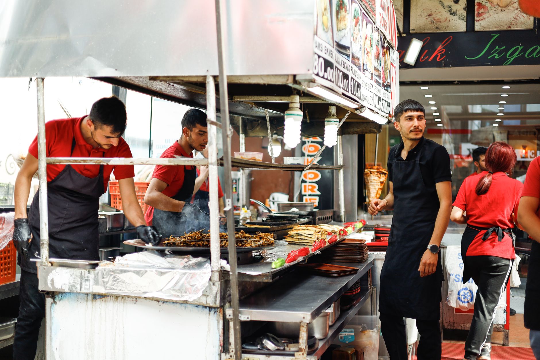 Guests dine around tabletop grills in a busy all-you-can-eat restaurant.