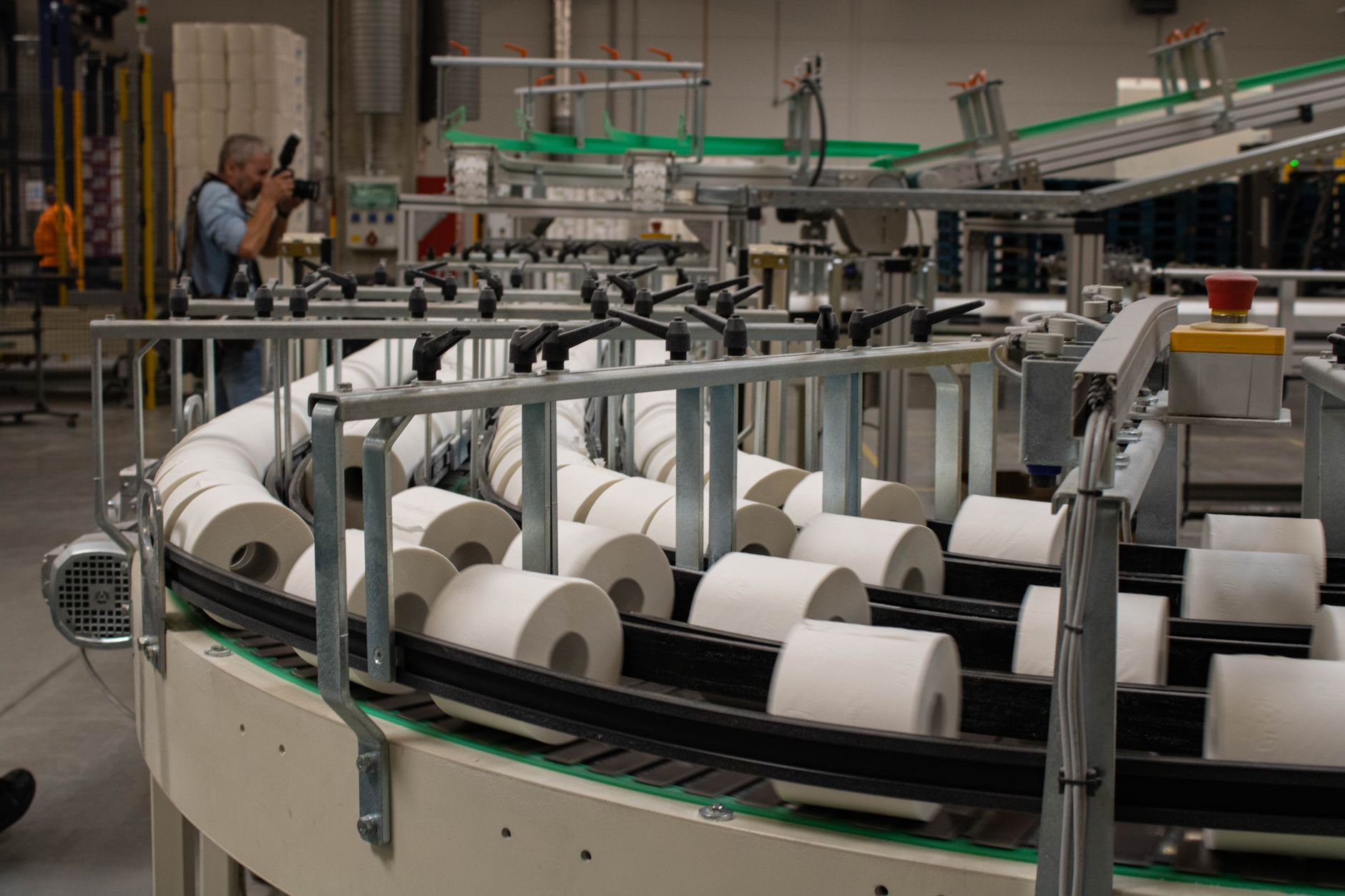 Sacks feeding from a roller conveyor toward an automated palletizer.