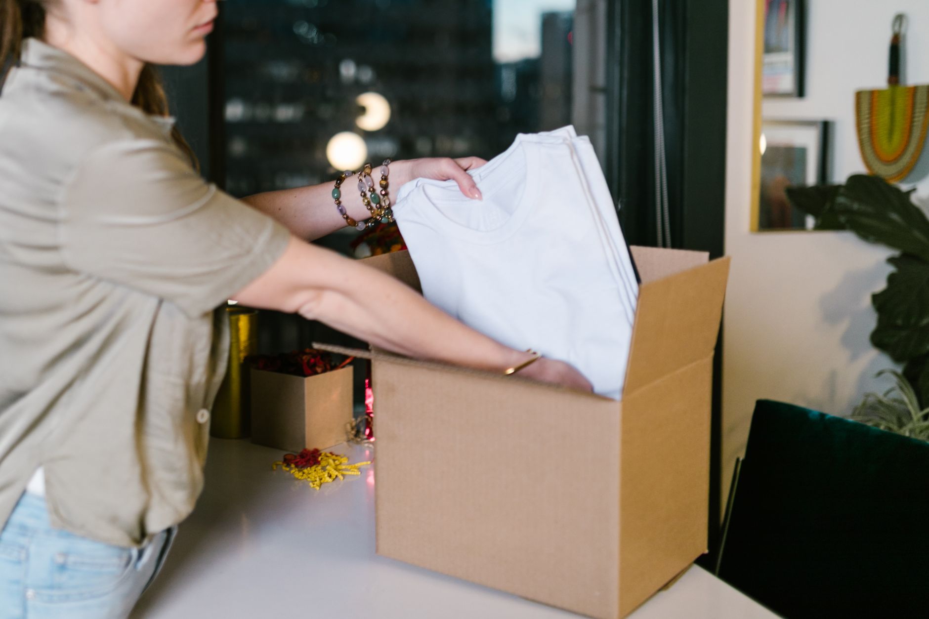Folded apparel inventory staged for order fulfillment after productivity gains at pick stations.