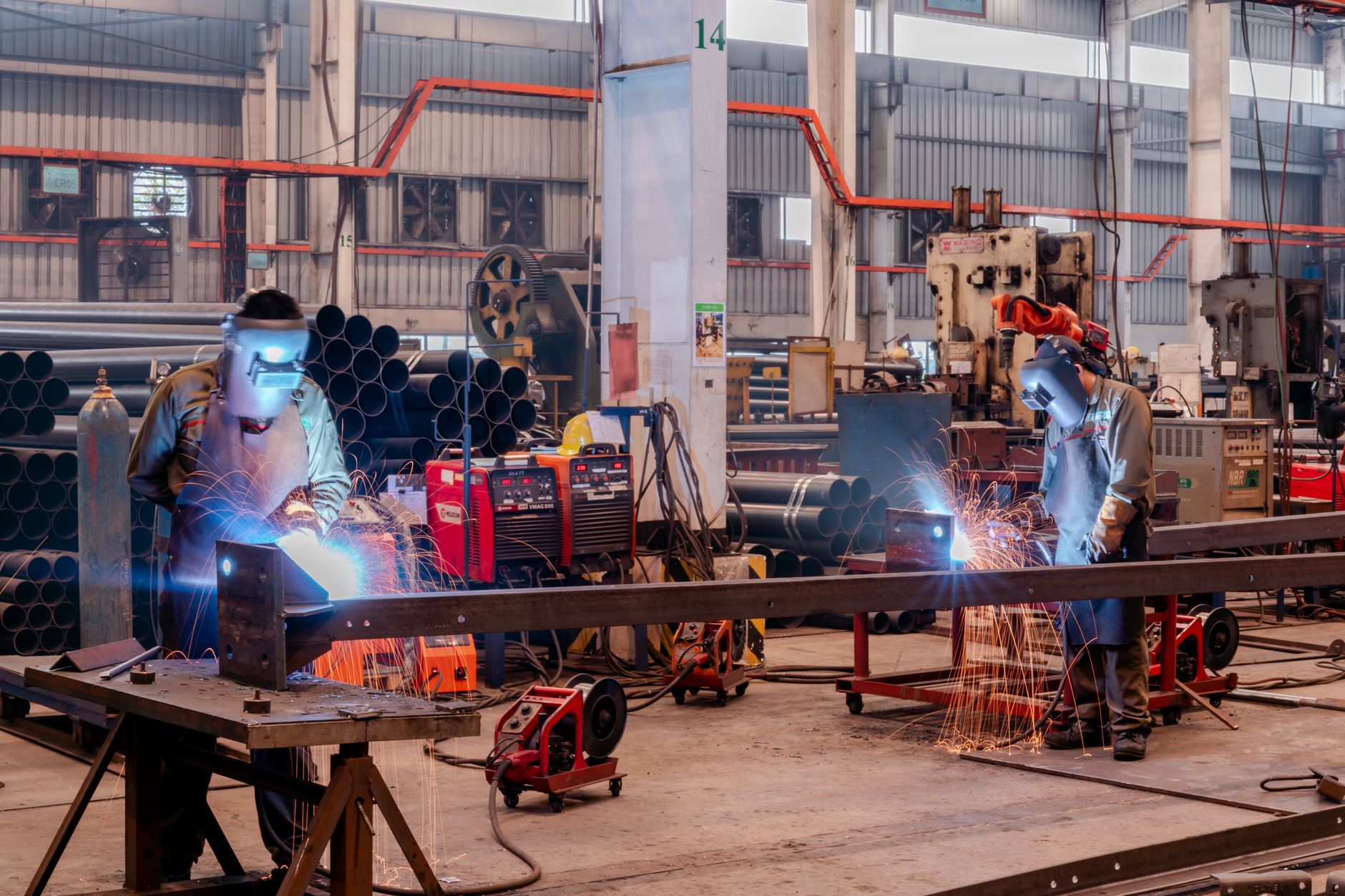 Wide view of an automotive assembly floor with vehicle bodies moving along a production line.