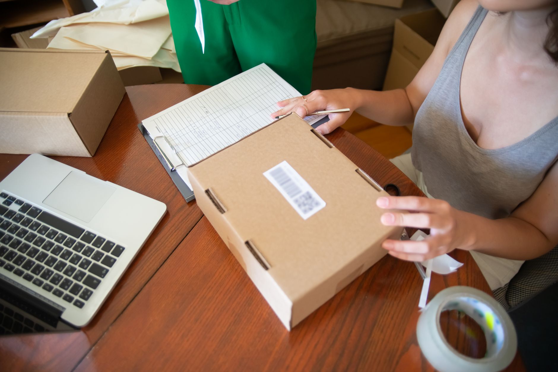 Associates pack orders at a fulfillment bench.