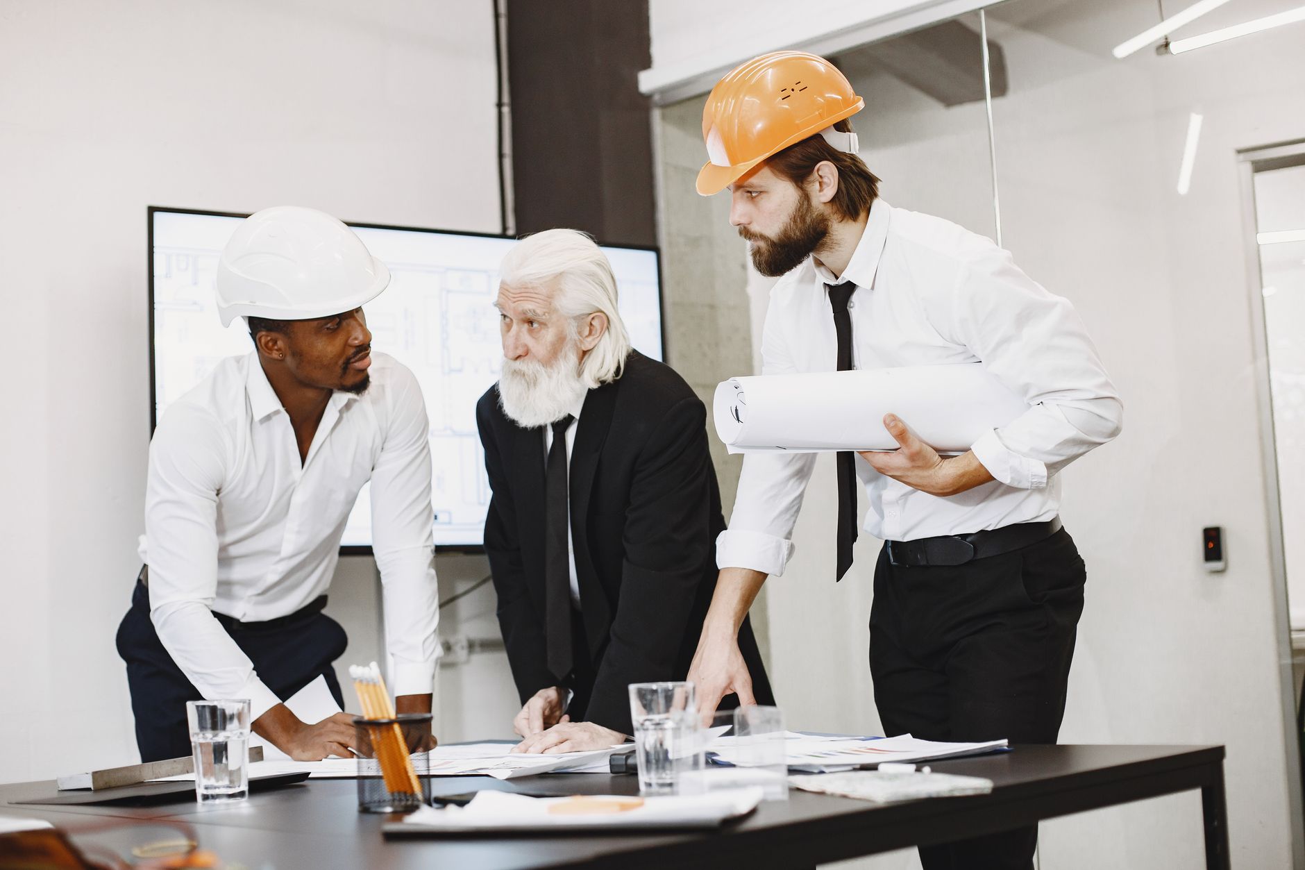An engineering team reviews production plans together before a manufacturing deployment.
