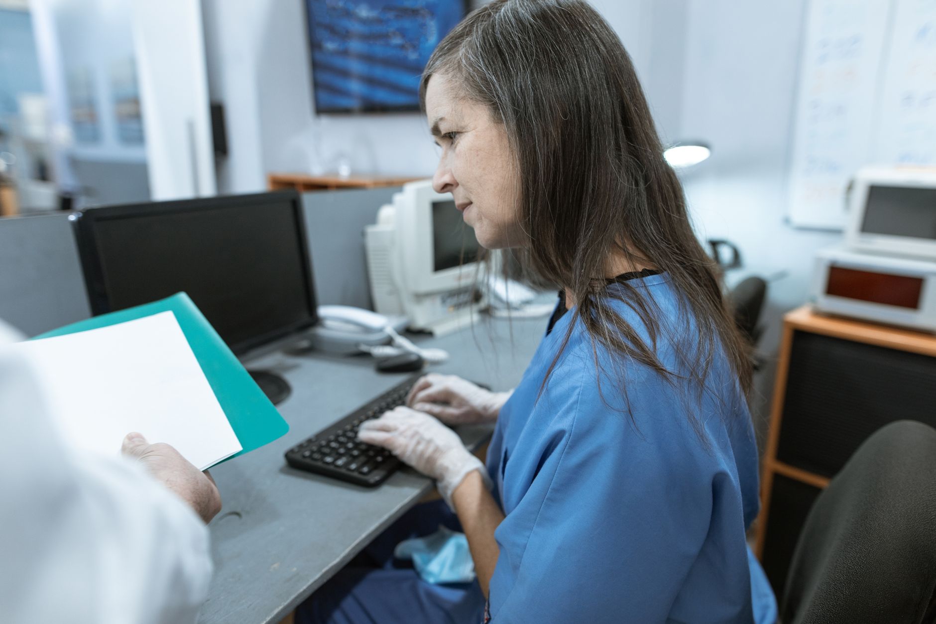 A clinical workstation highlights the nursing time that returns when robots handle scope distribution and retrieval loops.
