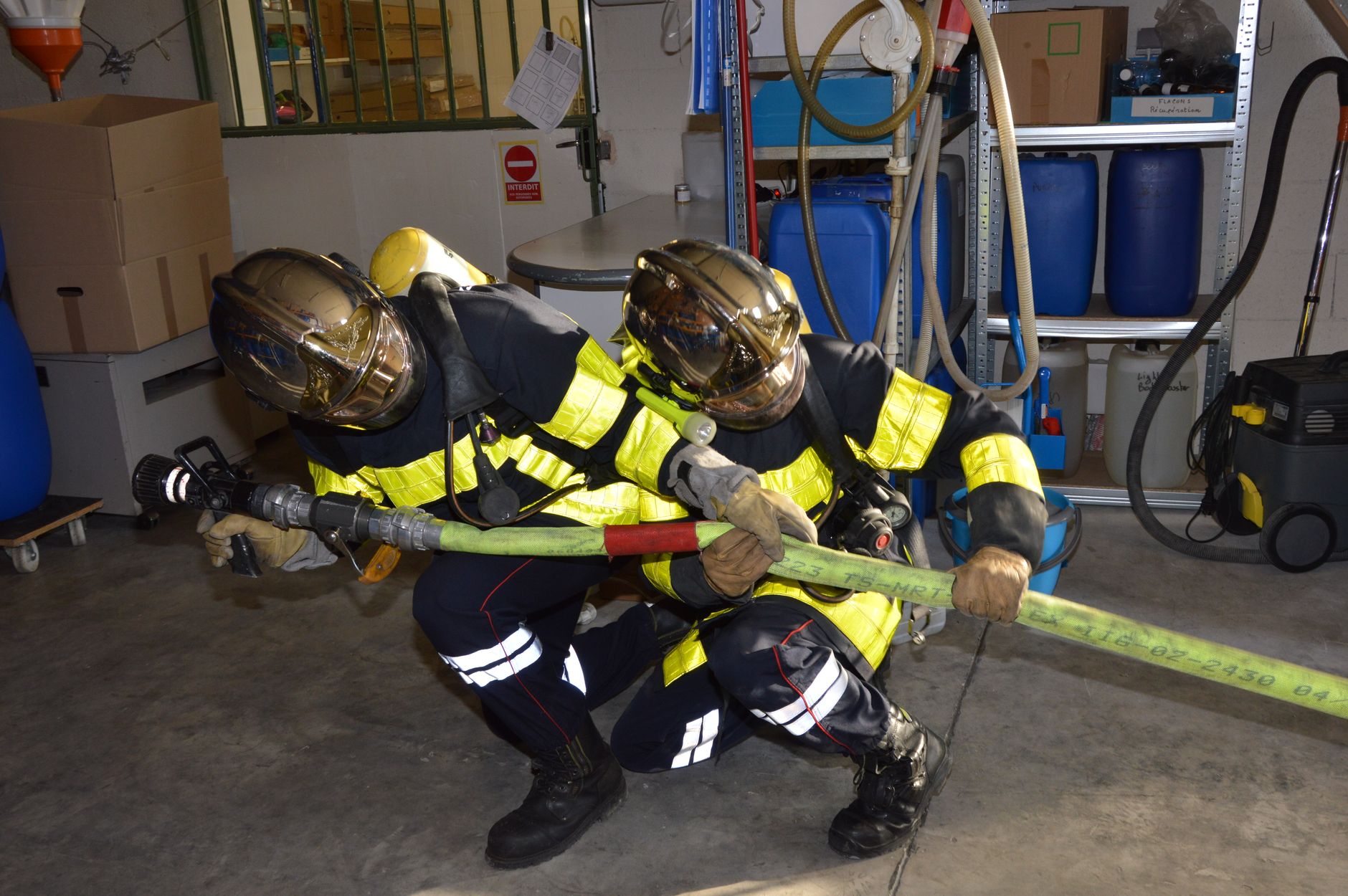 Fulfillment team members review procedures together on a warehouse floor.