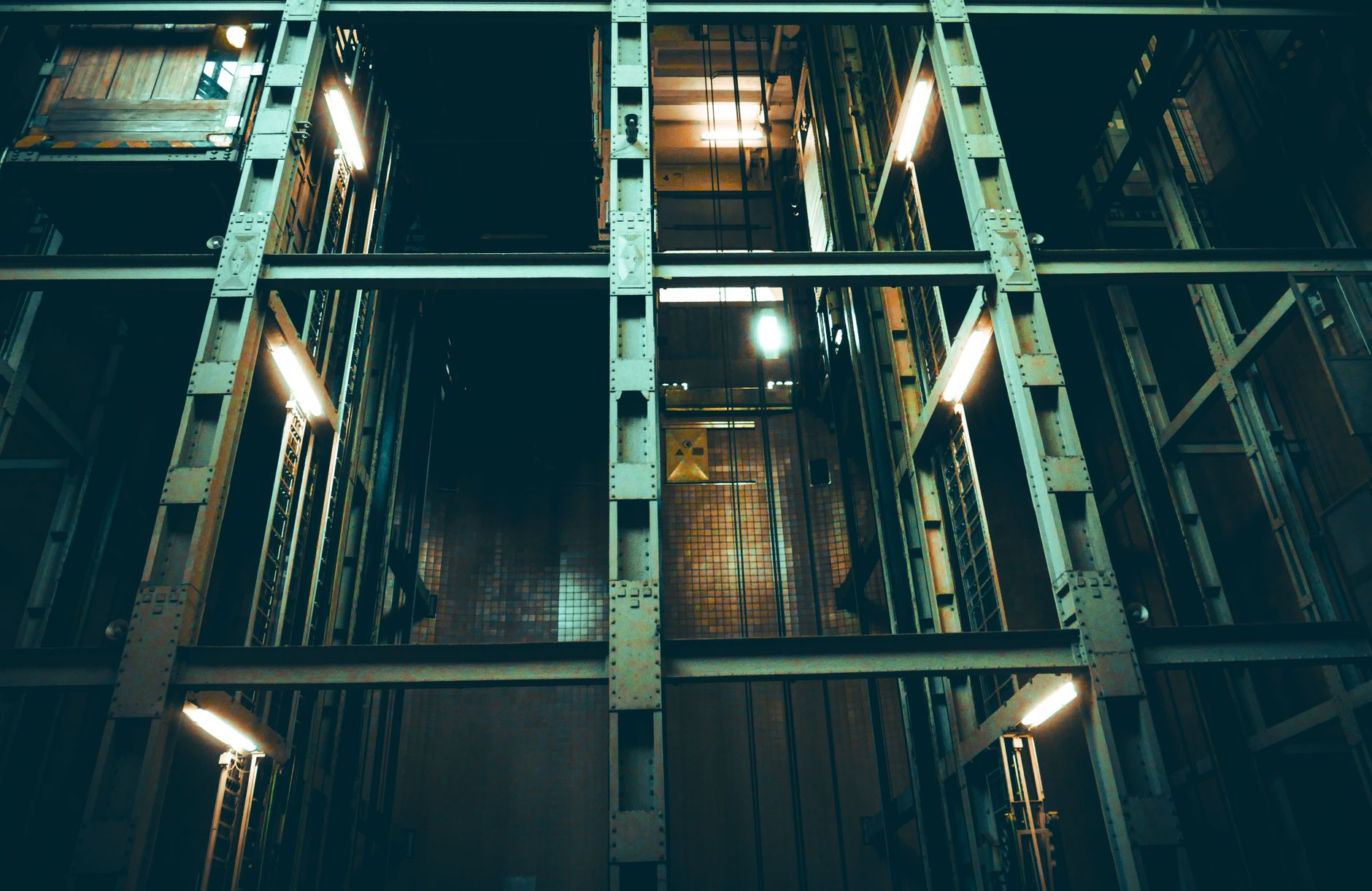 Exposed steel and temporary walls inside an active commercial construction site where supervisors once walked hour-long progress patrols.
