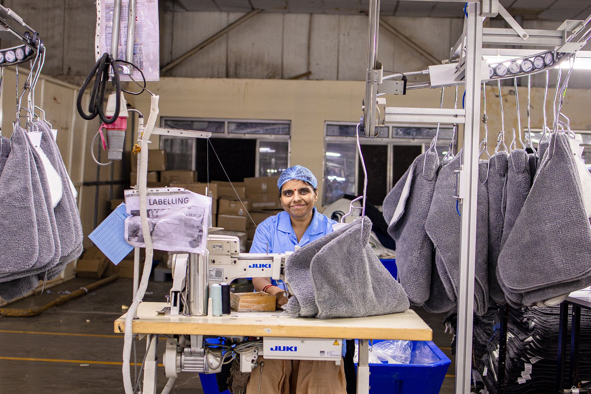Factory staff reviewing production flow after a process improvement reduced overtime and eased staffing pressure.