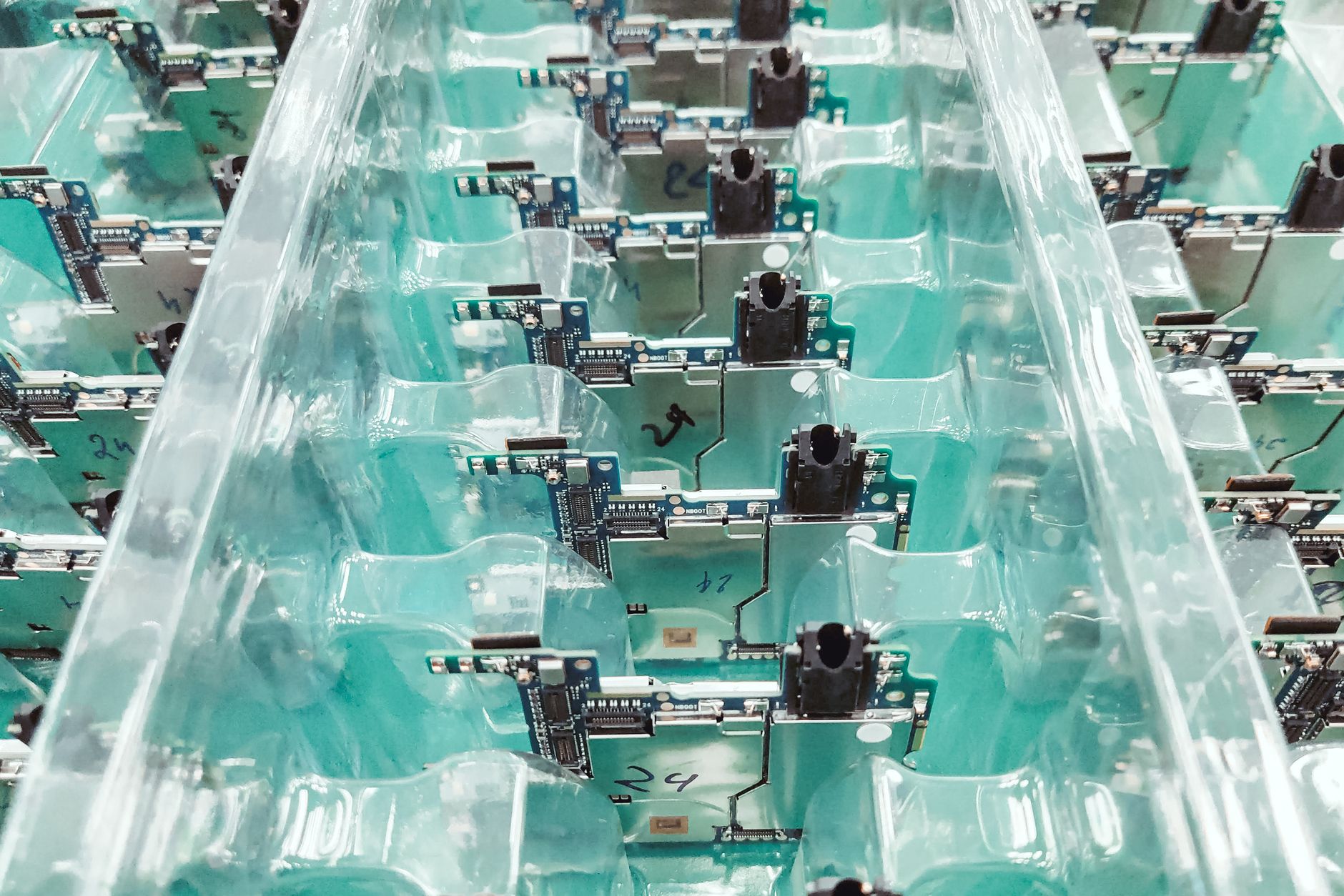 Technicians working along an electronics assembly line where downstream testing speed and consistency matter.