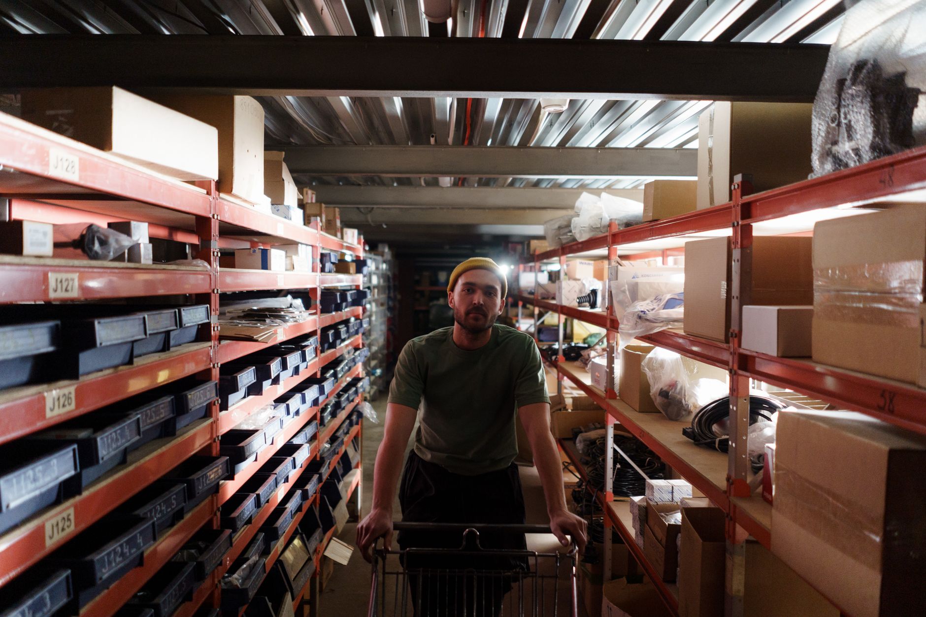 Industrial parts shelves in a fulfillment area where high-mix SKUs move through daily picking.