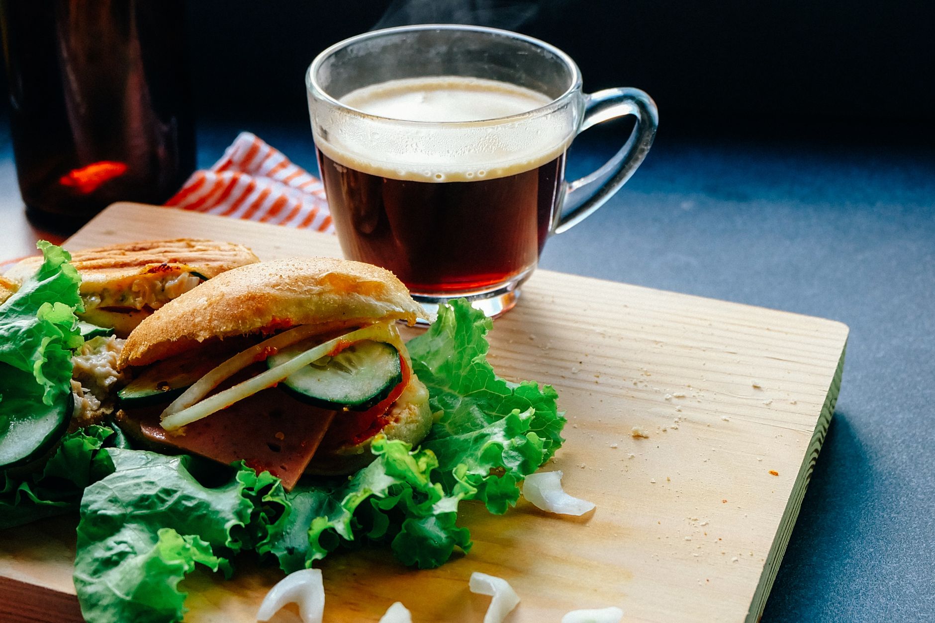 A breakfast sandwich and coffee represent the small food orders delivered across the campus.