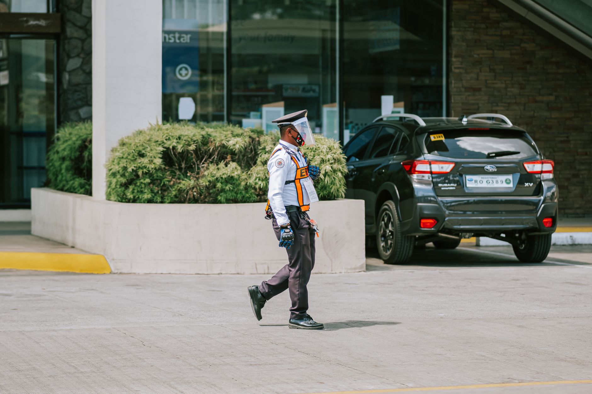 A security guard walking an office-campus parking area, illustrating the added patrol layer that supported the site’s existing team.